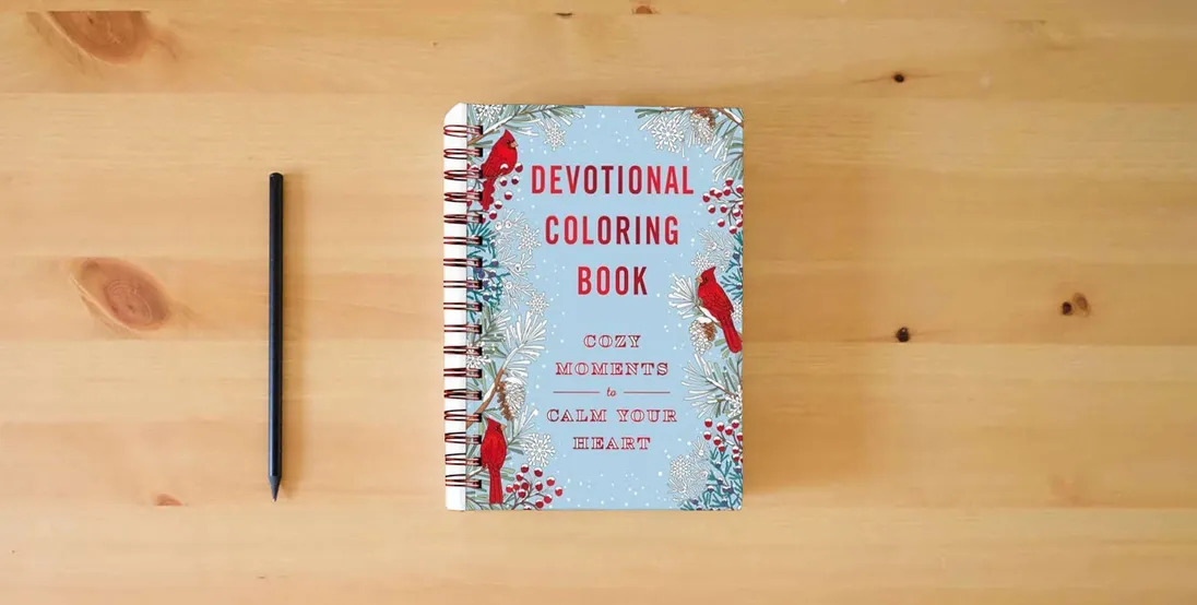 The book Cozy Moments to Calm Your Heart: Devotional Coloring Book} is on the table