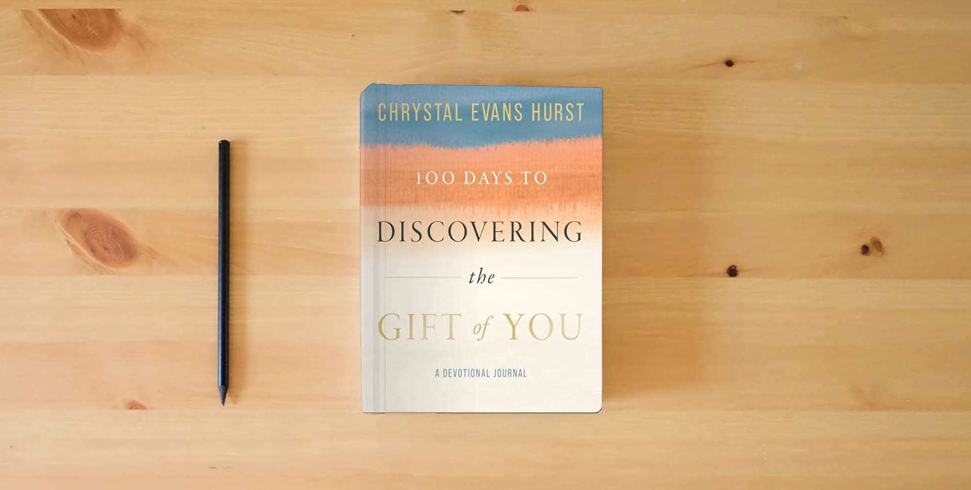 The book 100 Days to Discovering the Gift of You: A Devotional Journal is on the table