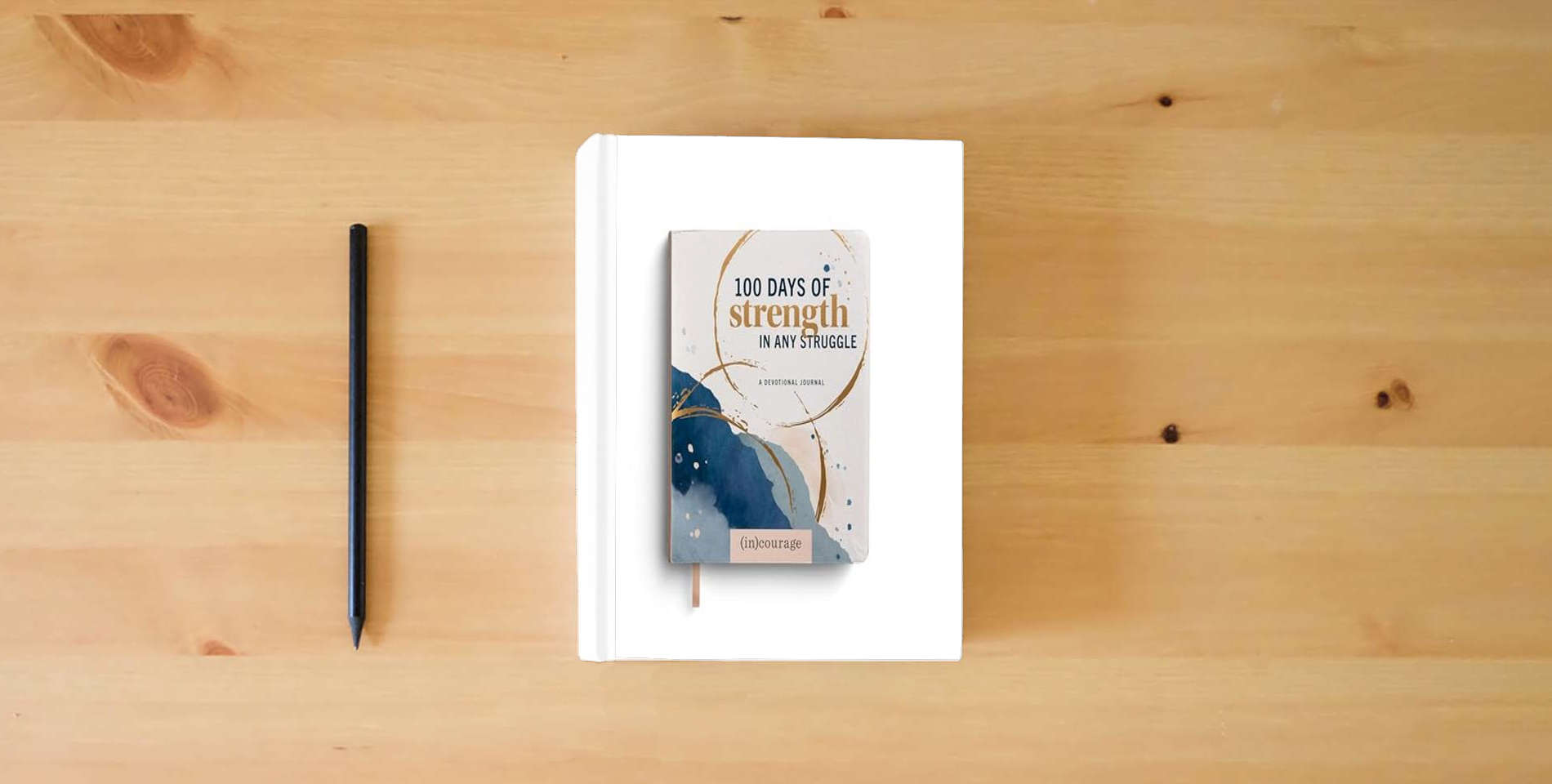 The book 100 Days of Strength in Any Struggle: A Devotional Journal is on the table