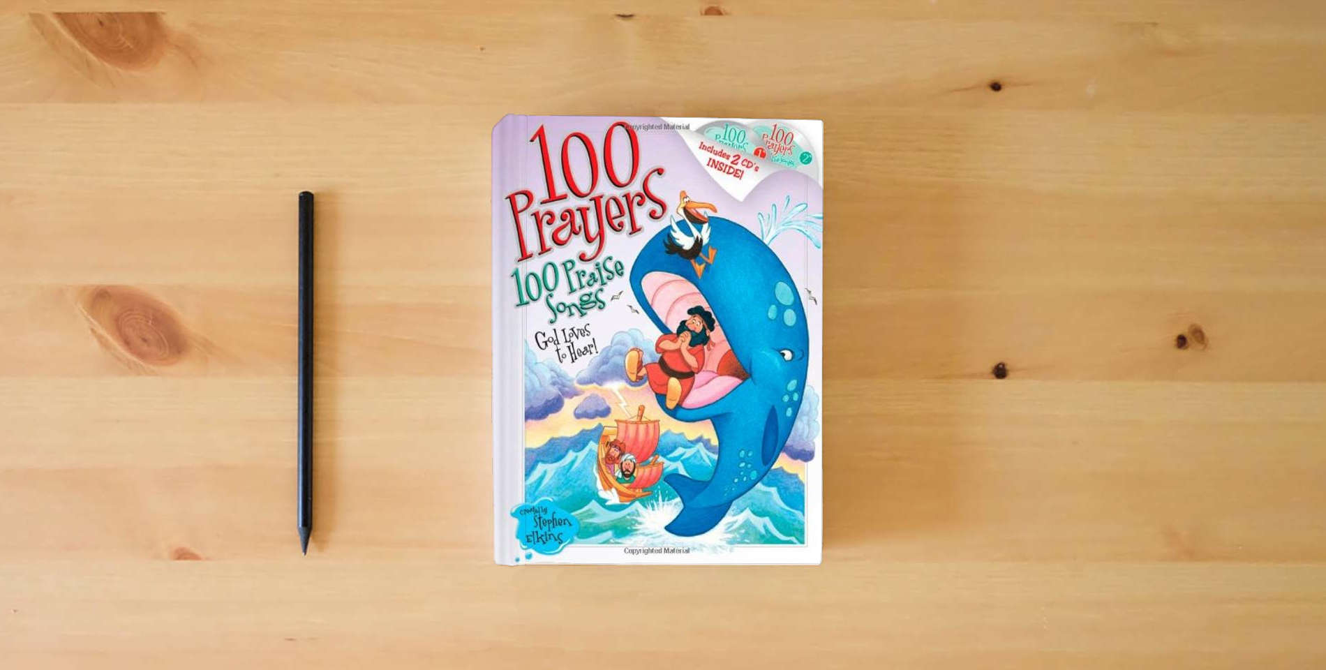 The book 100 Prayers God Loves to Hear, 100 Praise Songs is on the table