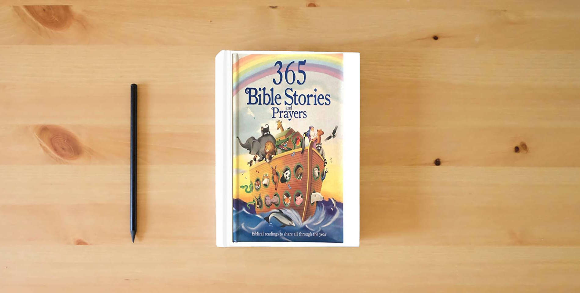 The book 365 Bible Stories and Prayers Padded Treasury - Gift for Easter, Christmas, Communions, Baptism, Birthdays (Little Sunbeams) is on the table