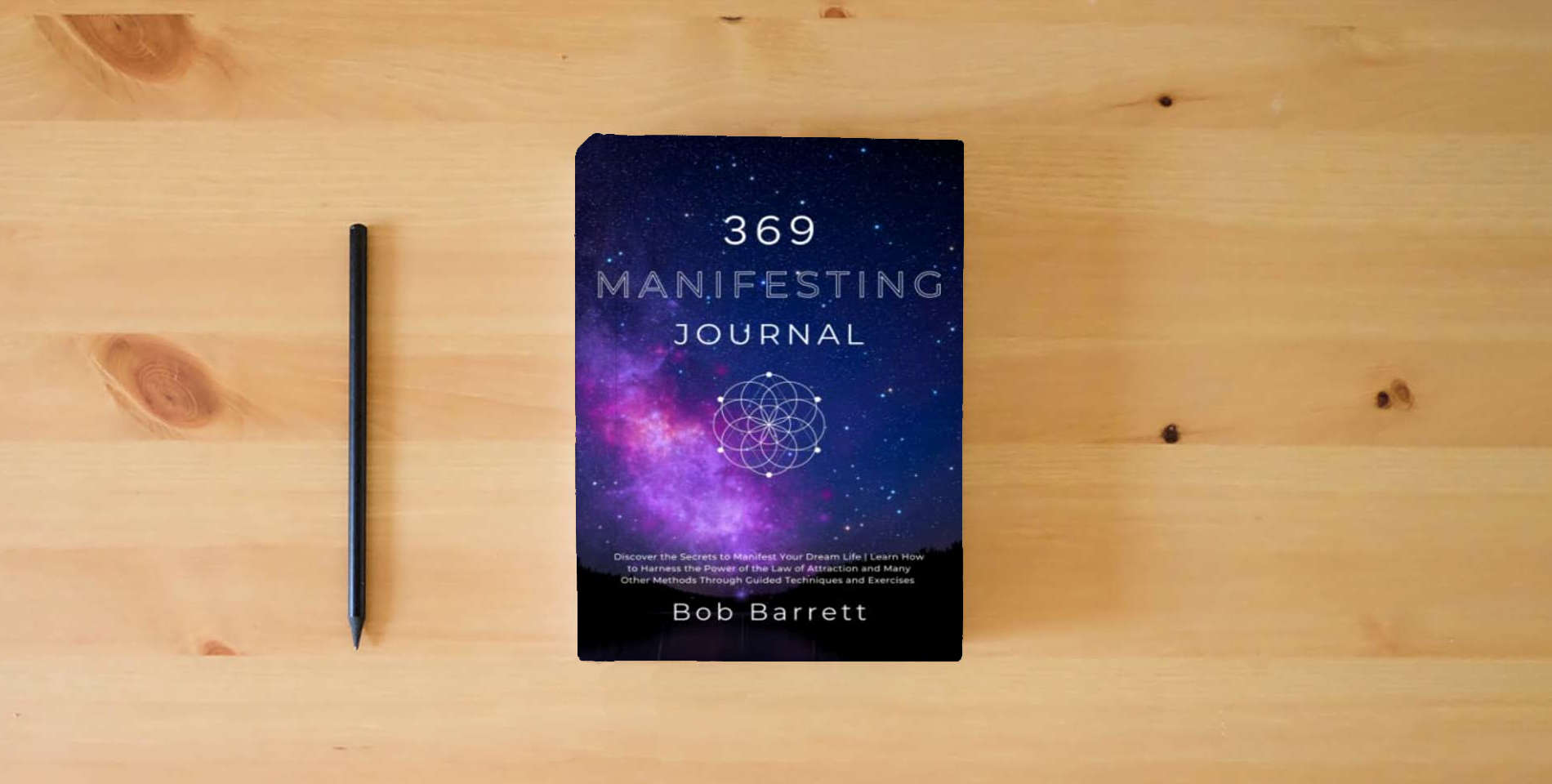 The book 369 Manifesting Journal: Discover the Secrets to Manifest Your Dream Life | Learn How to Harness the Power of the Law of Attraction and Many Other Methods Through Guided Techniques and Exercises is on the table