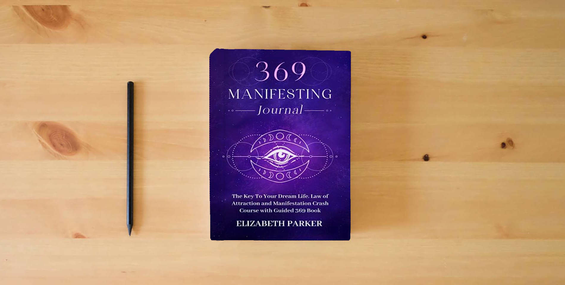 The book 369 Manifesting Journal: The Key to Your Dream Life. Law of Attraction and Manifestation Crash Course with Guided 369 Book is on the table