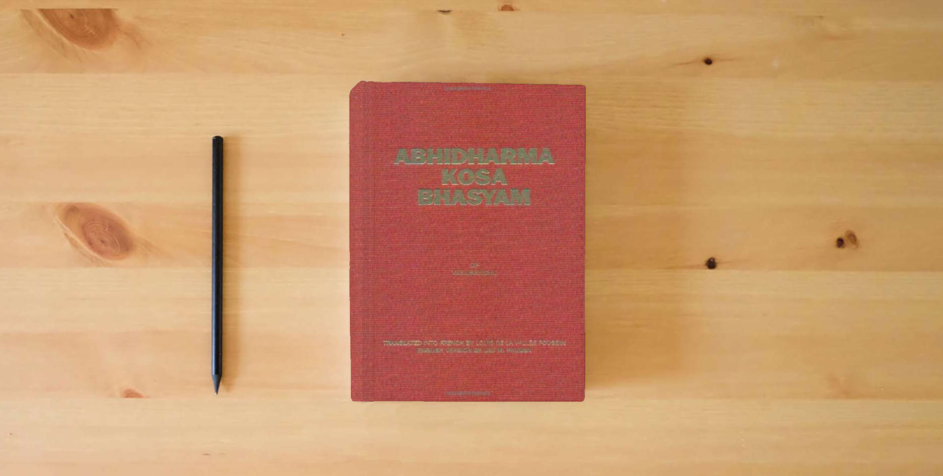 The book Abhidharmakosabhasyam, 4 Volume Set (English, French and Sanskrit Edition) is on the table