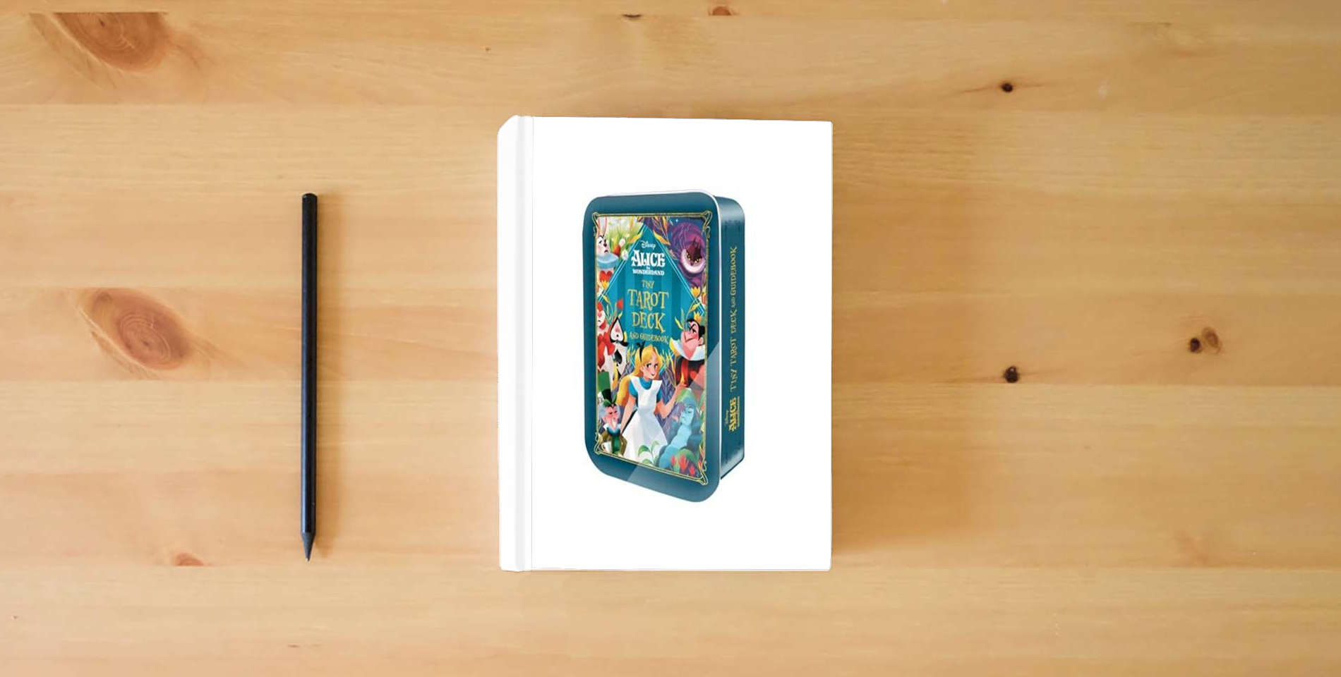 The book Alice in Wonderland Tiny Tarot Deck and Guidebook is on the table