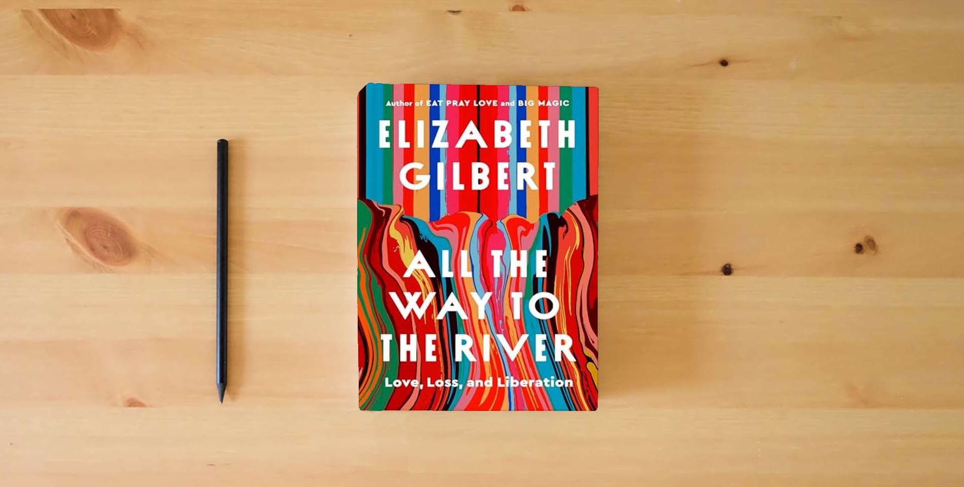 The book All the Way to the River: Love, Loss, and Liberation is on the table