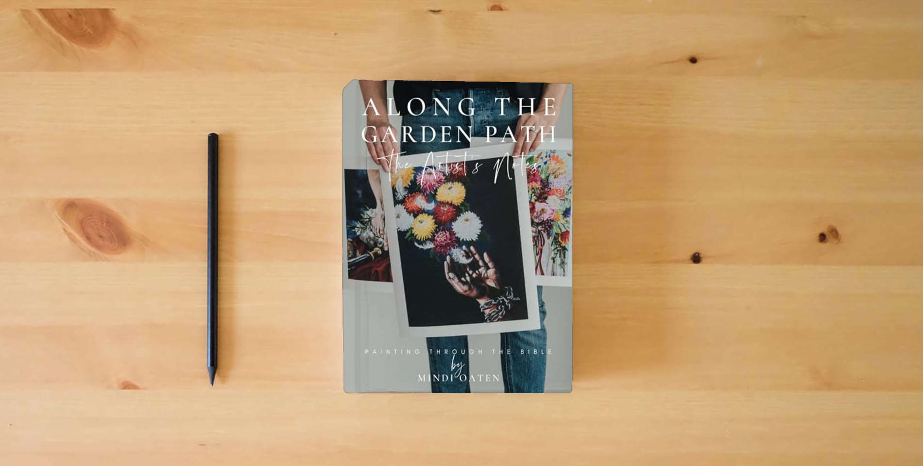 The book Along the Garden Path, The Artist's Notes on Painting the Bible: Painting through the Bible is on the table
