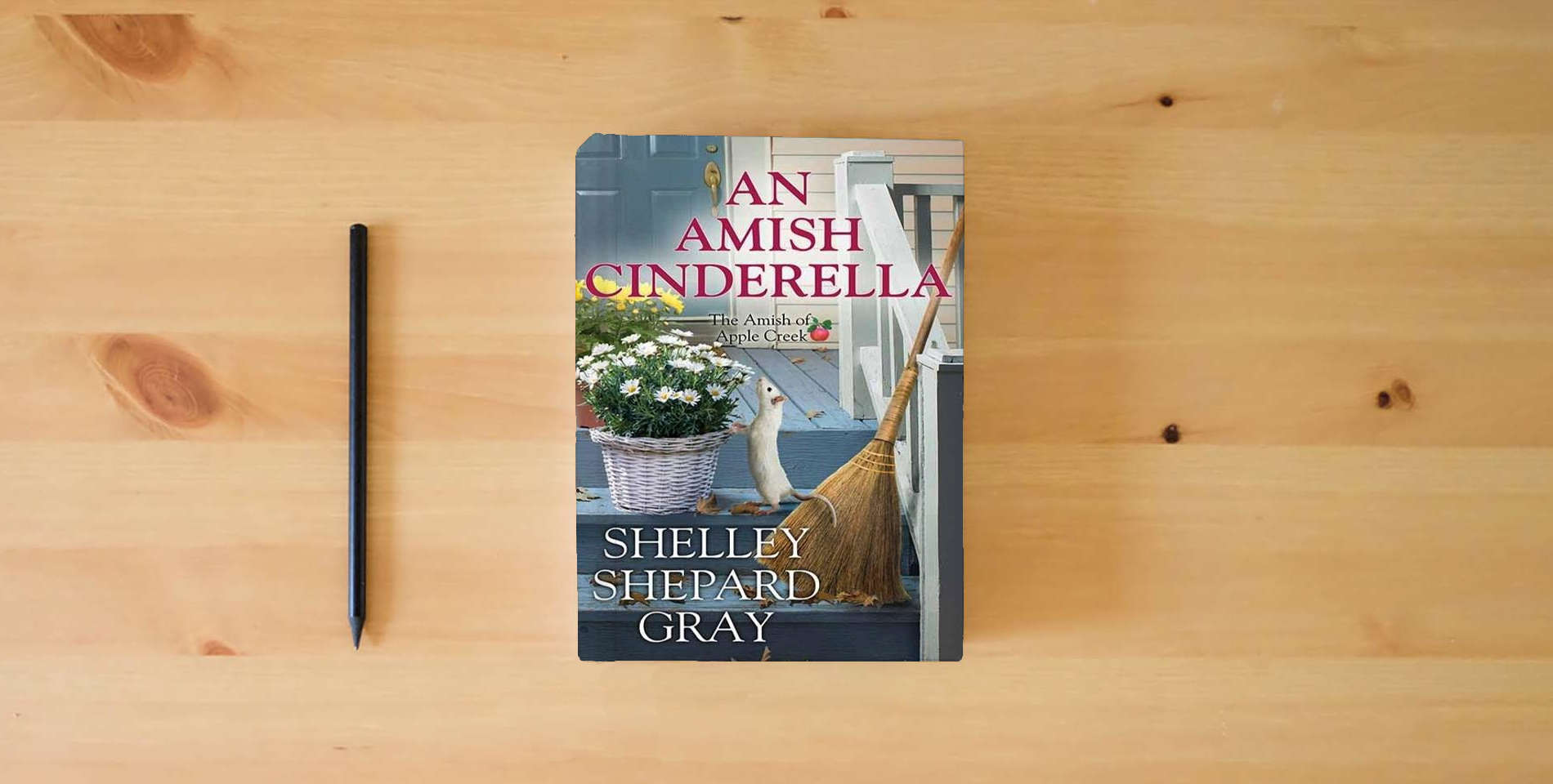 The book An Amish Cinderella: The Amish of Apple Creek is on the table