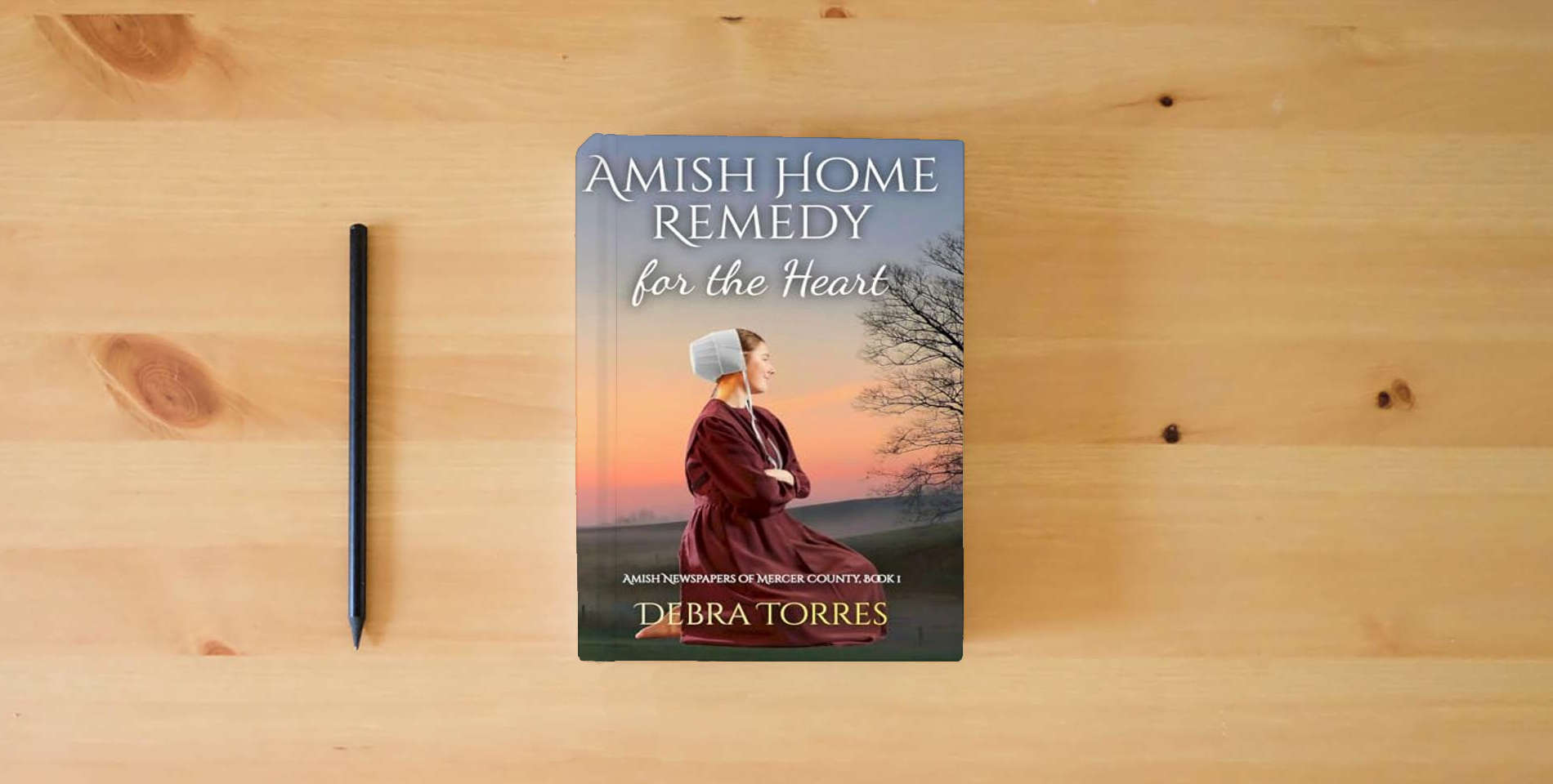 The book Amish Home Remedy for the Heart: Amish Christian Romance Novel (Amish Newspapers of Mercer County) is on the table