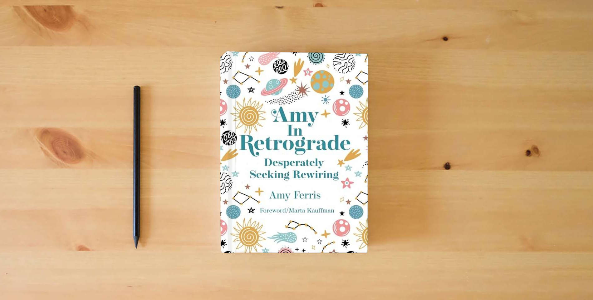 The book Amy in Retrograde: Desperately Seeking Rewiring is on the table