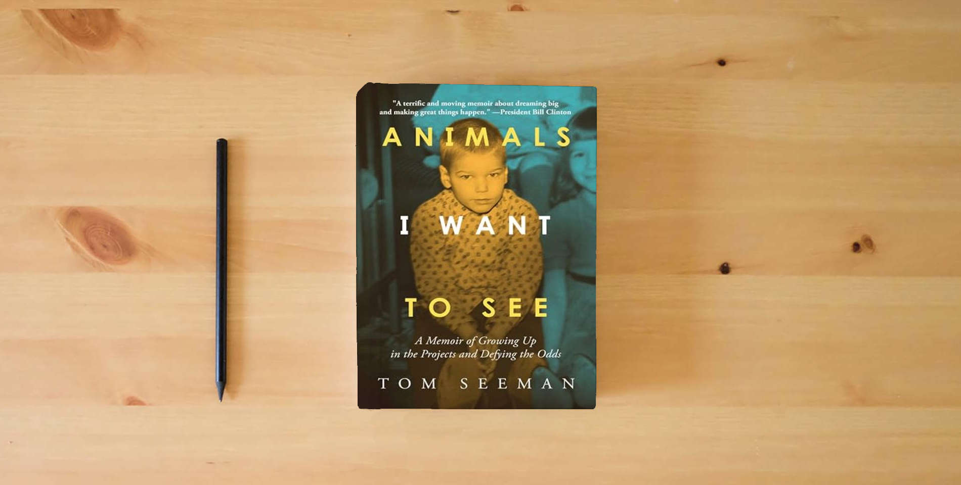 The book Animals I Want To See: A Memoir of Growing Up in the Projects and Defying the Odds is on the table