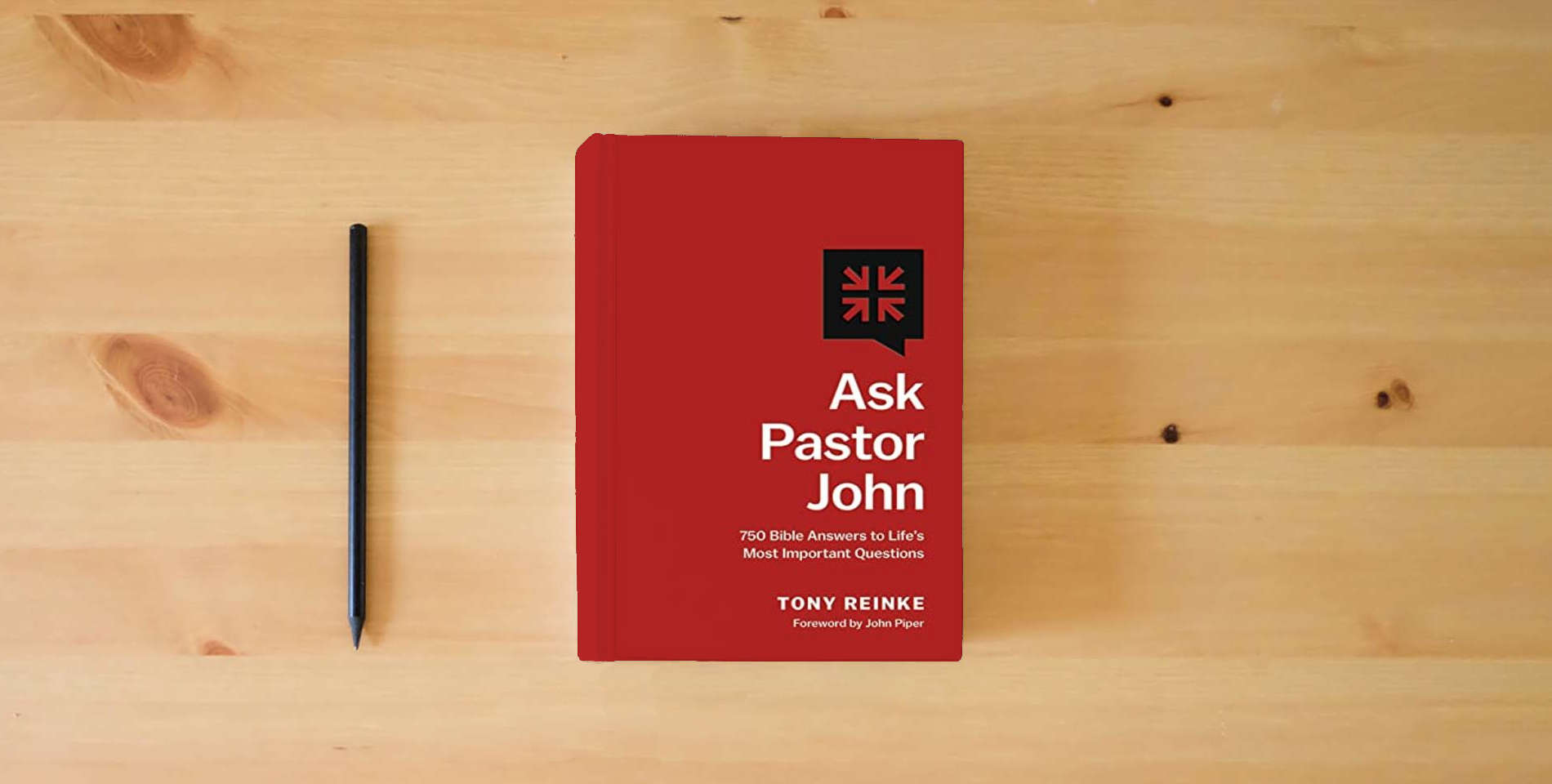 The book Ask Pastor John: 750 Bible Answers to Life's Most Important Questions is on the table