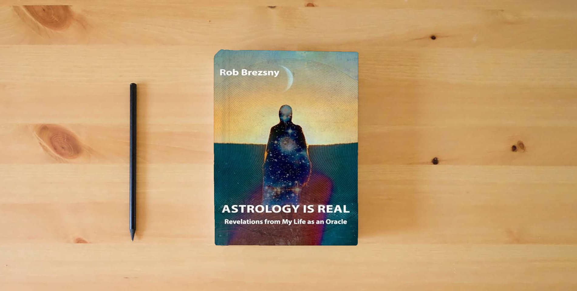 The book Astrology Is Real: Revelations from My Life as an Oracle is on the table