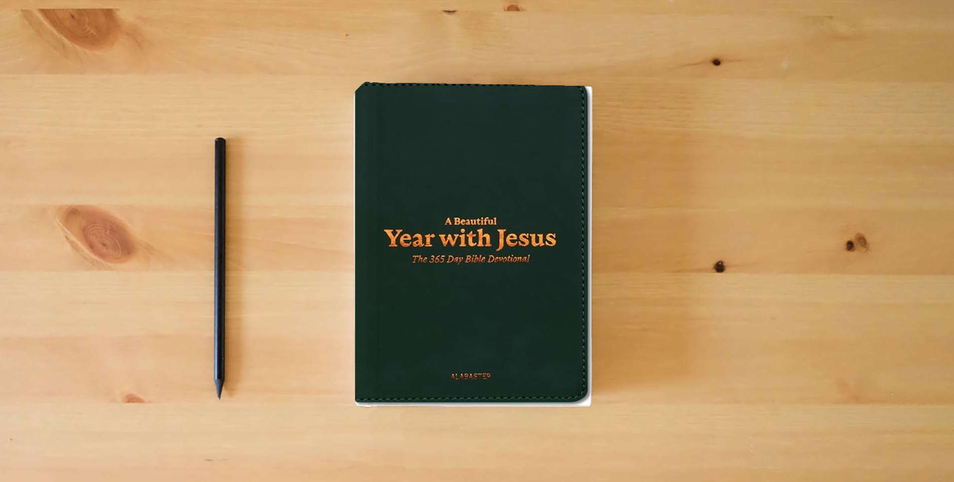 The book A Beautiful Year with Jesus (LB): The Daily Devotional For 365 Days in the Bible is on the table