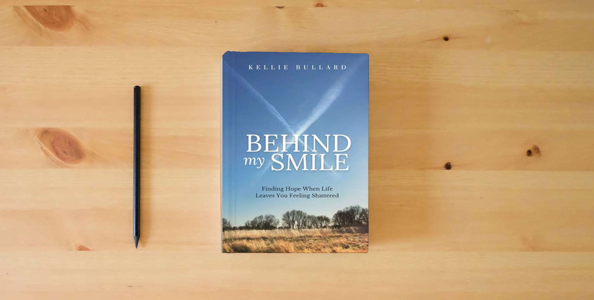 The book Behind My Smile: Finding Hope When Life Leaves You Feeling Shattered is on the table