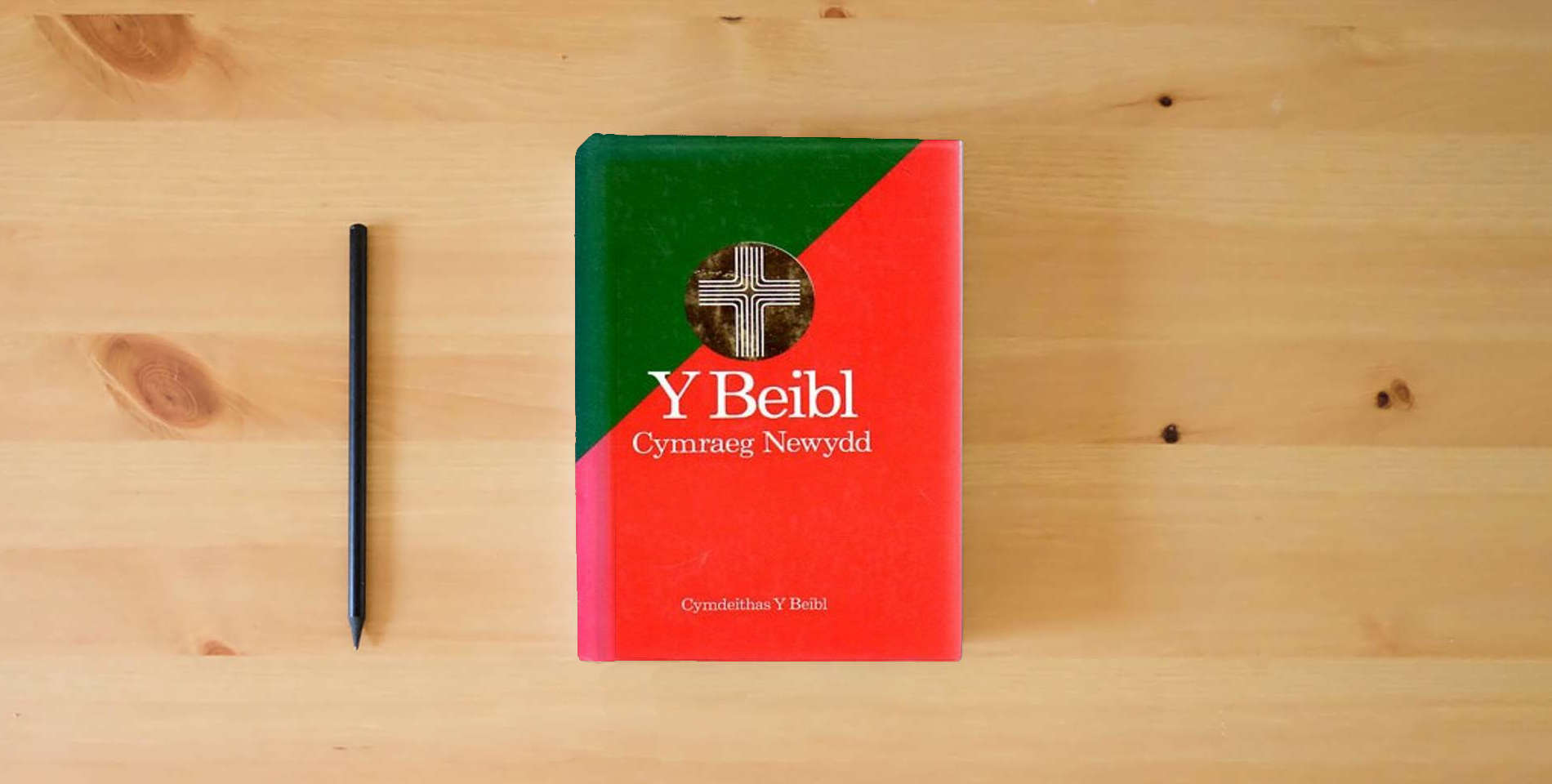 The book Y Beibl Cymraeg Newydd (New Welsh Bible) is on the table