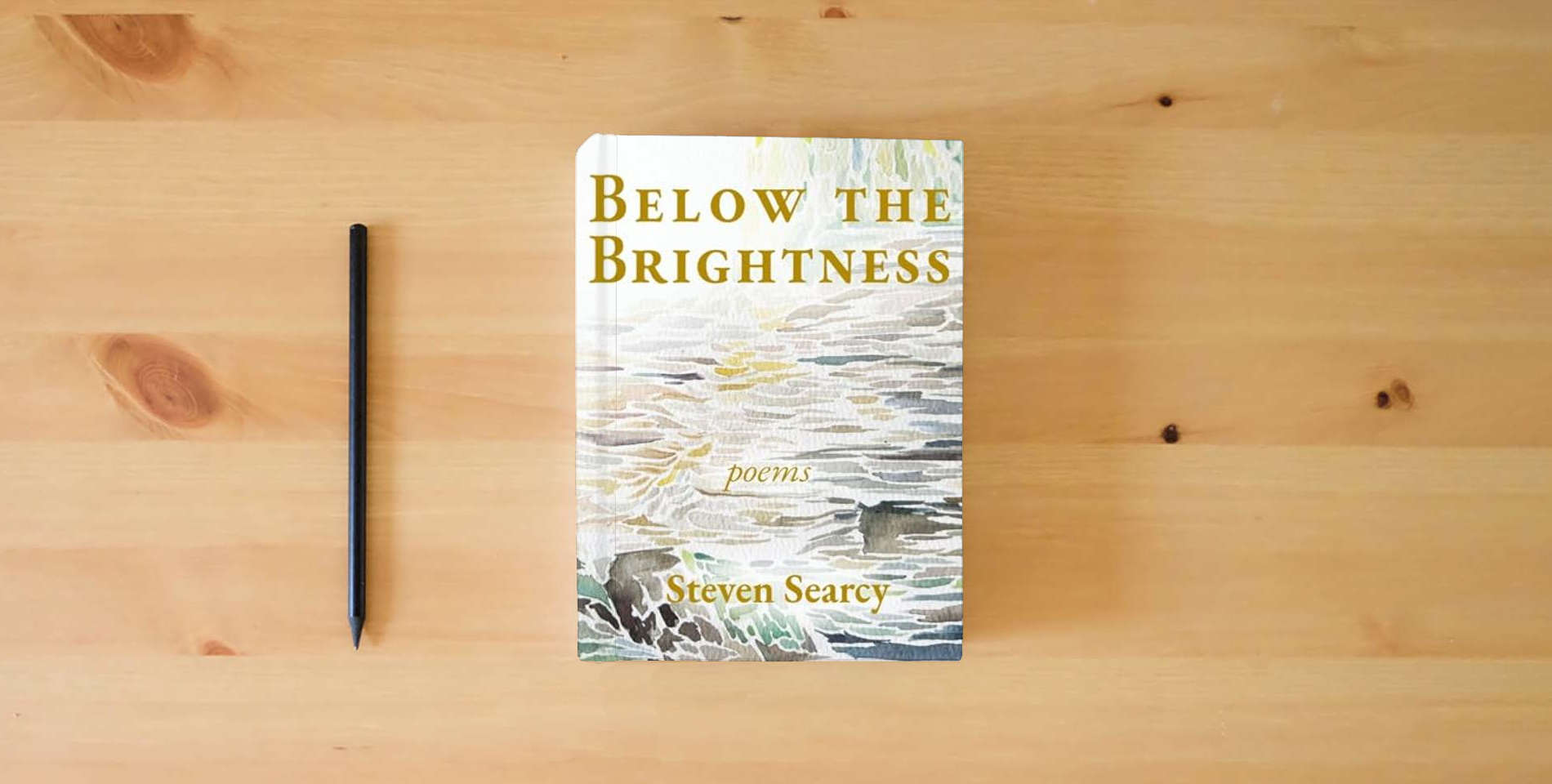 The book Below the Brightness is on the table