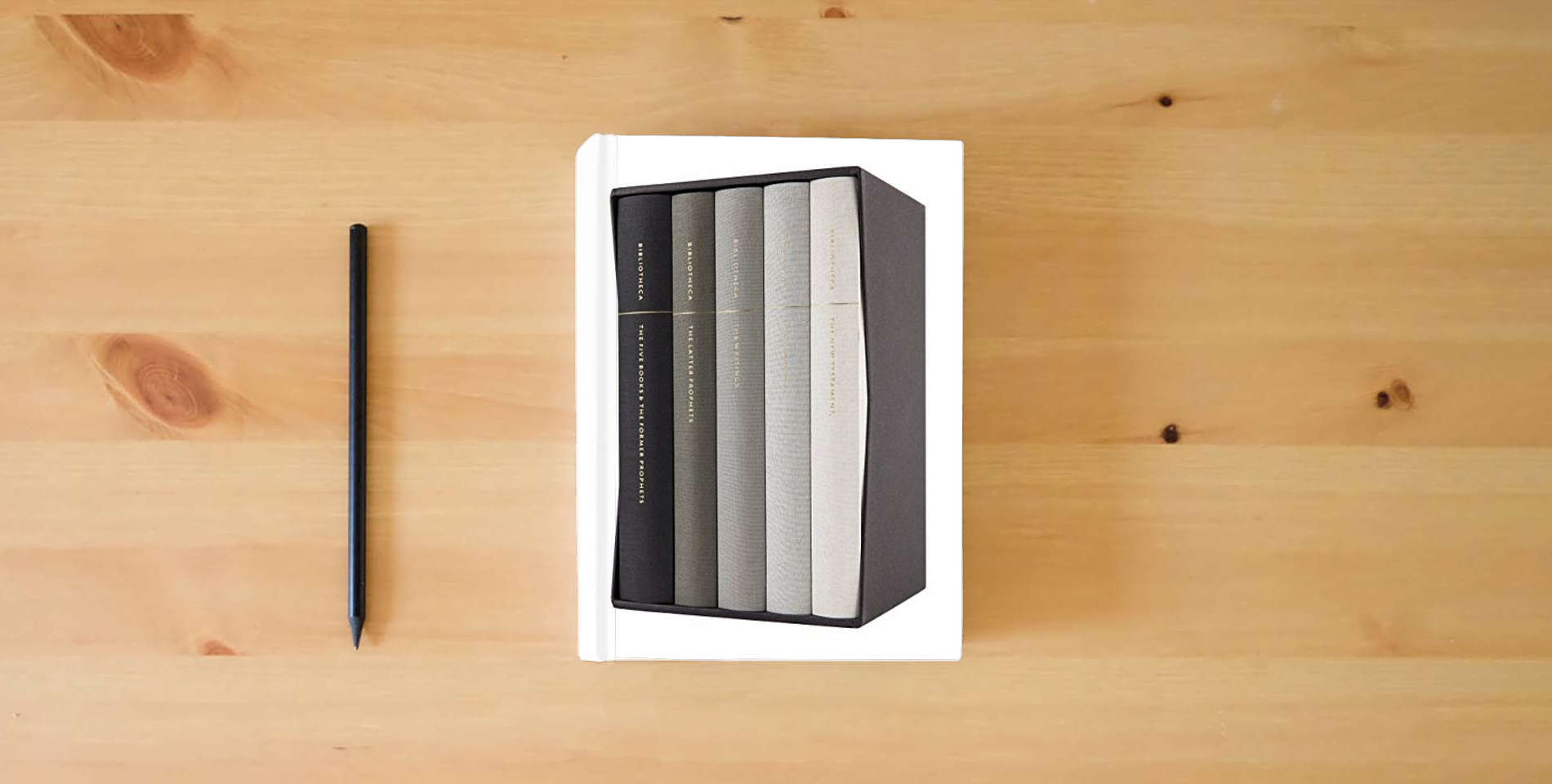 The book Bibliotheca: Complete Multi-volume Reader's Bible Clothbound Set, 5 Volumes (Including the Apocrypha) is on the table