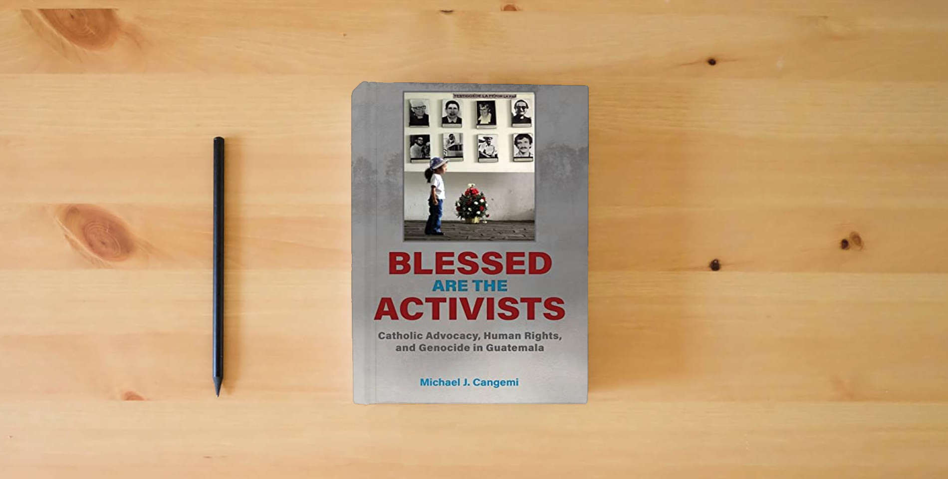 The book Blessed Are the Activists: Catholic Advocacy, Human Rights, and Genocide in Guatemala is on the table