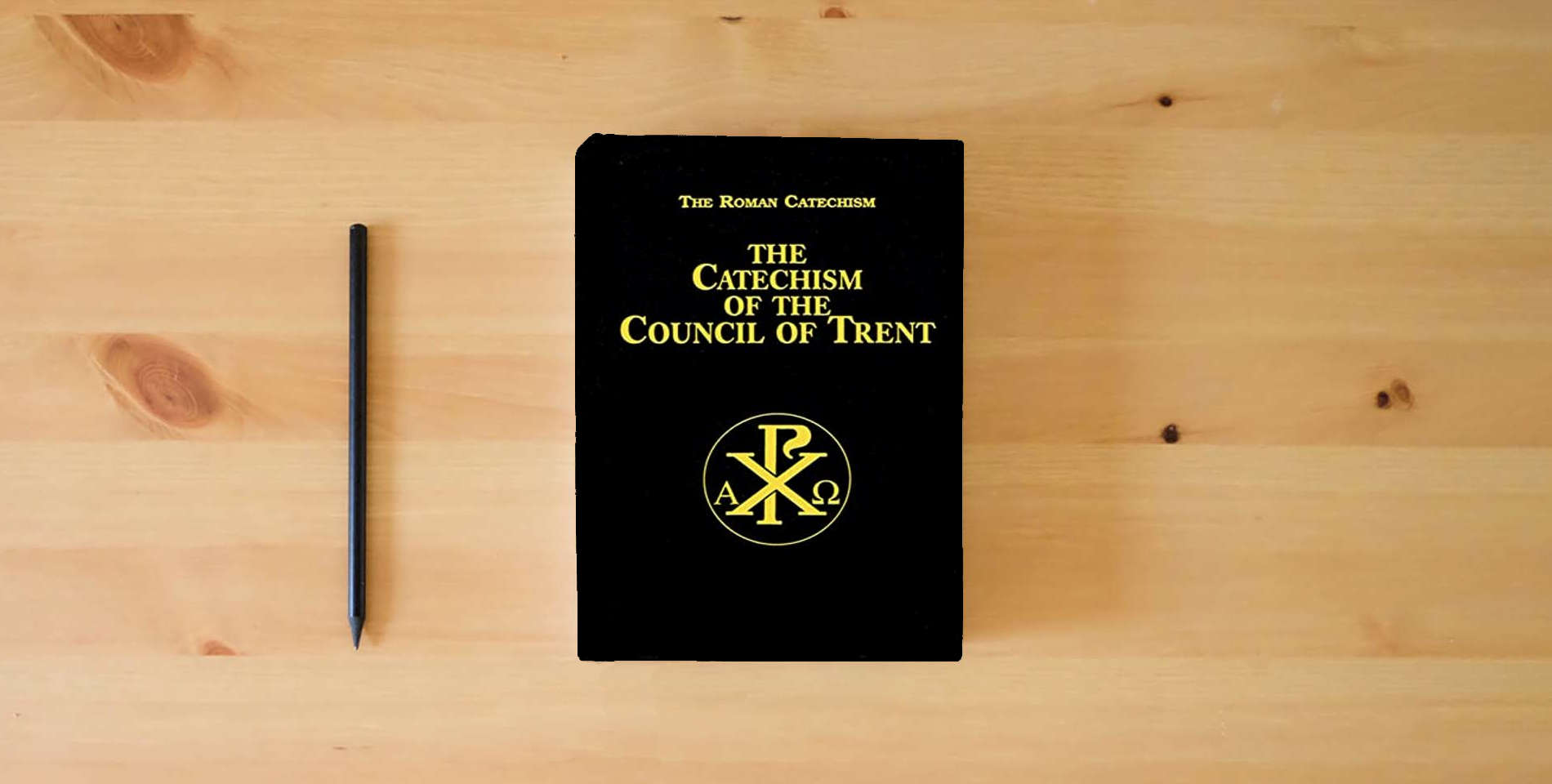 The book Catechism of the Council of Trent is on the table