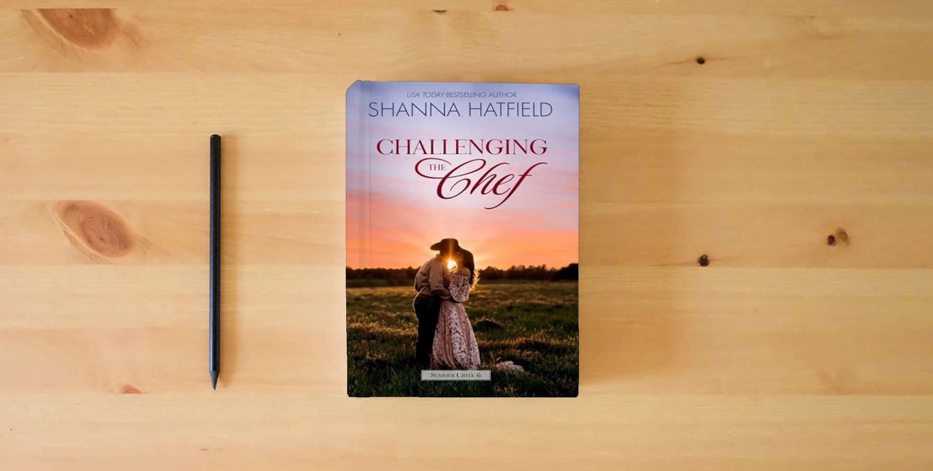 The book Challenging the Chef: A Small-Town Clean Romance (Summer Creek) is on the table