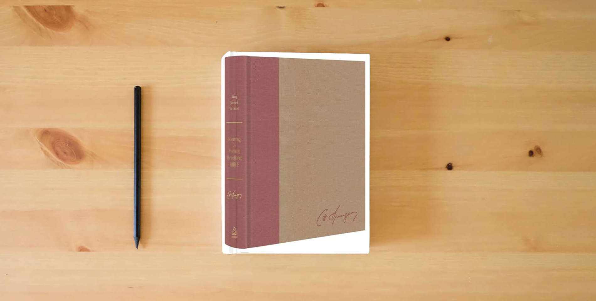 The book Charles Spurgeon's Morning & Evening Devotional Bible KJV [Rose Gold & Sand Signature]: Featuring the Complete Text of the Classic Twice-A-Day Devotional is on the table