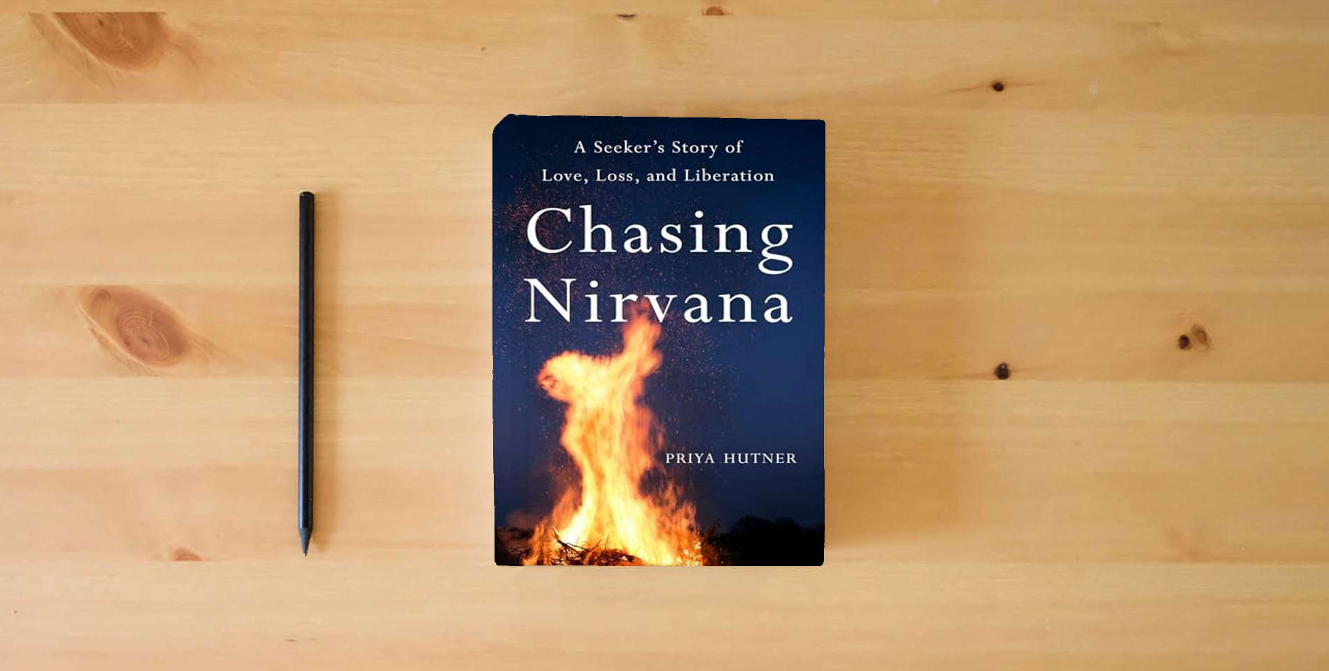 The book Chasing Nirvana: A Story of Love, Loss, and Liberation is on the table