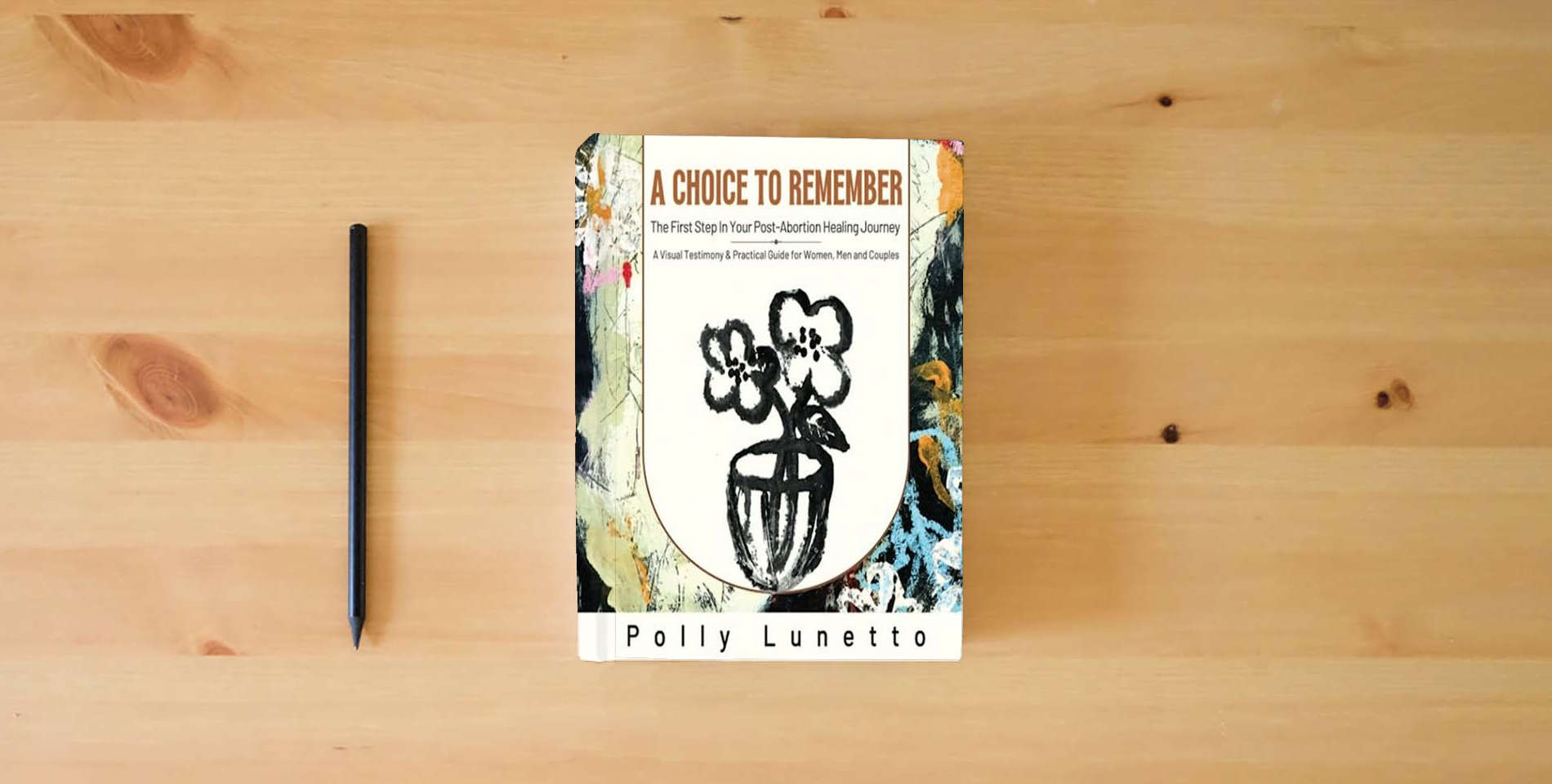 The book A Choice to Remember: The First Step in Your Post-Abortion Healing Journey is on the table