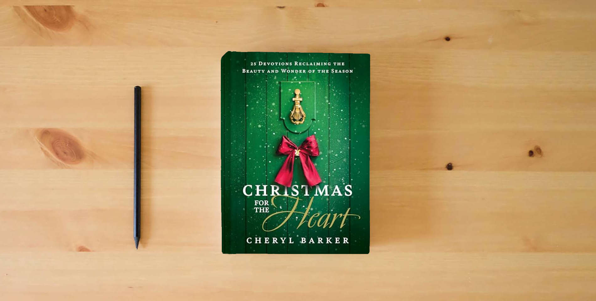 The book Christmas for the Heart: 25 Devotions Reclaiming the Beauty and Wonder of the Season is on the table