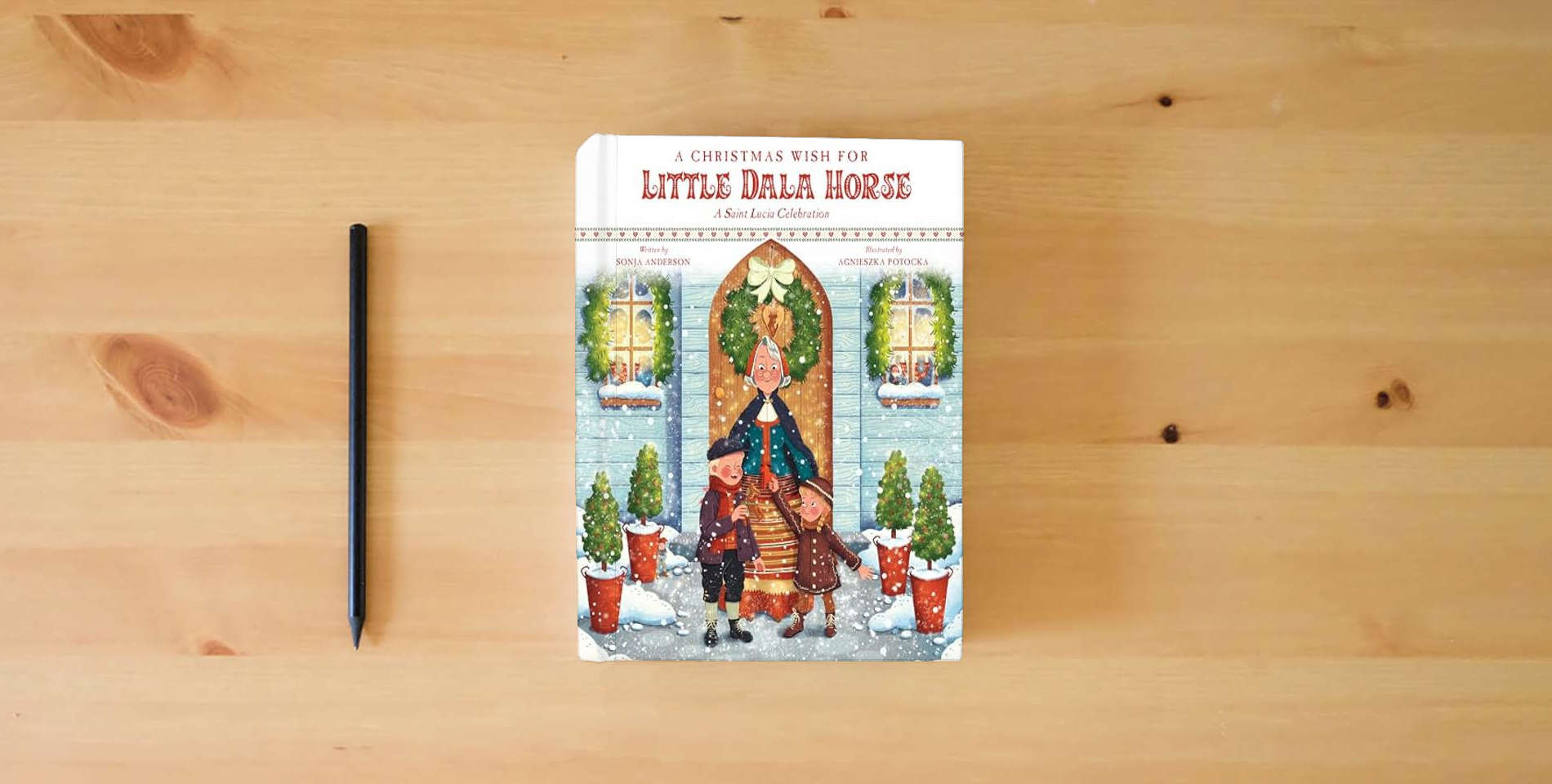 The book A Christmas Wish for Little Dala Horse: A Saint Lucia Celebration is on the table