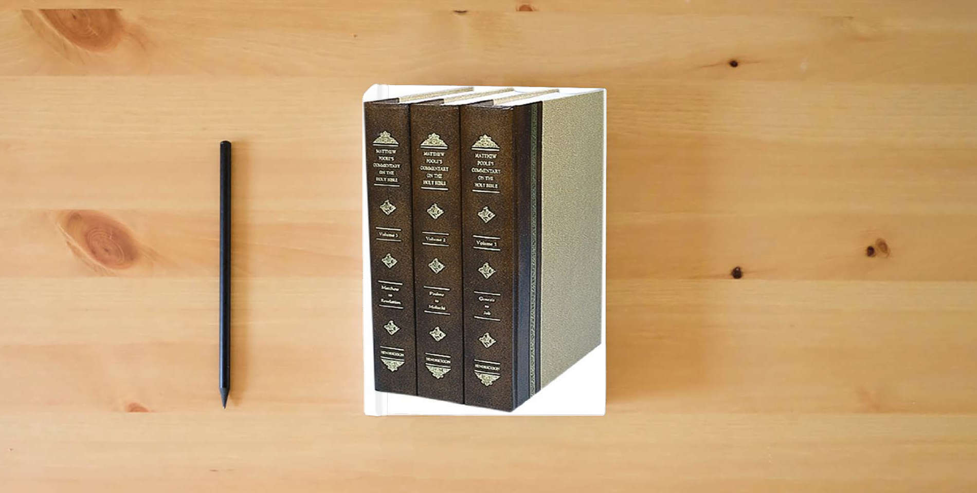The book A Commentary on the Holy Bible is on the table