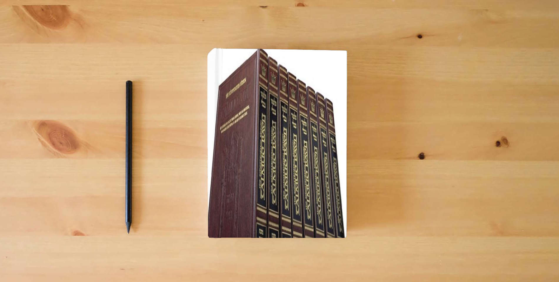 The book Complete Full Size Schottenstein Edition of the Talmud English Volumes (73 Volume Set) is on the table
