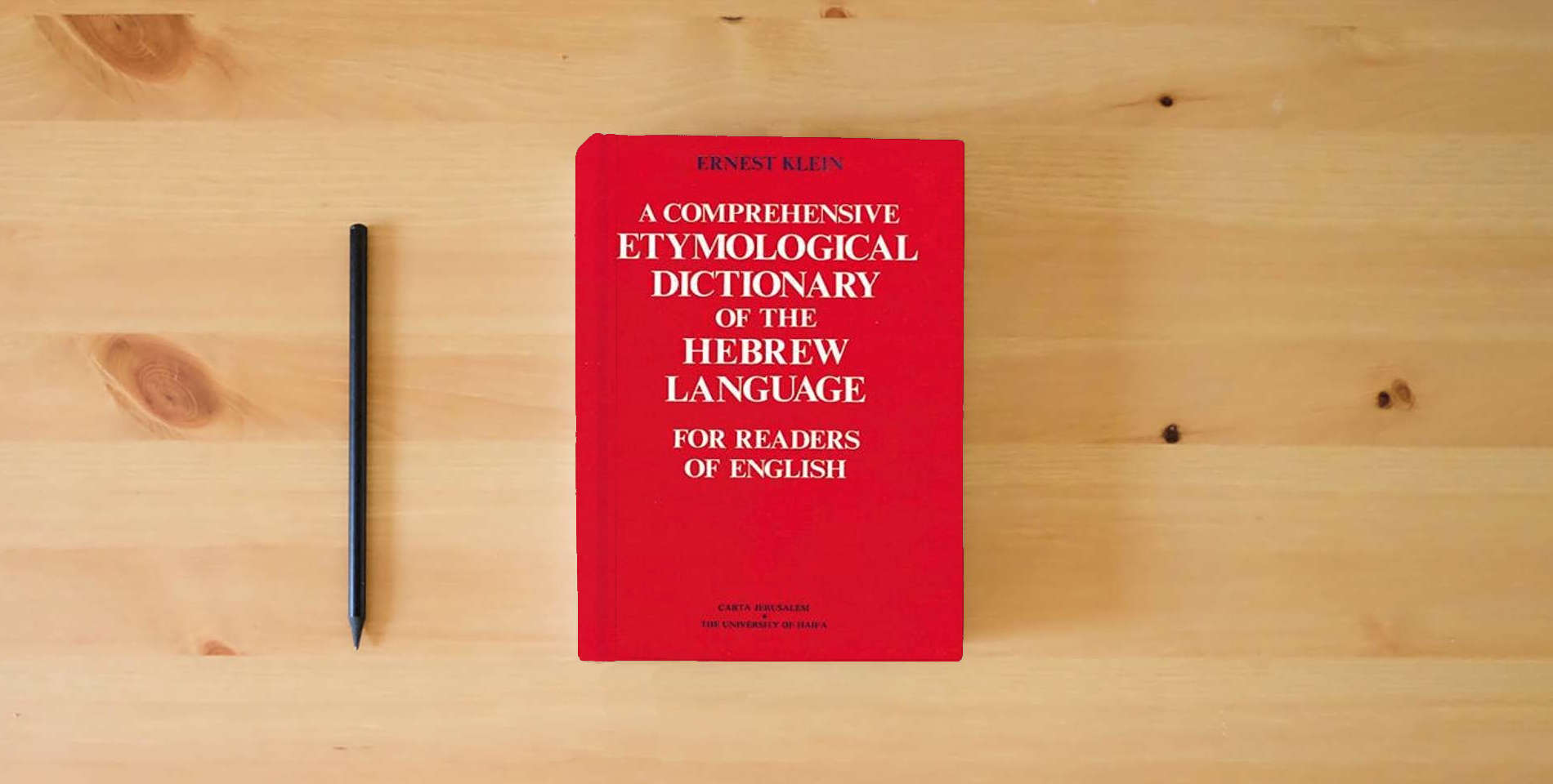 The book A Comprehensive Etymological Dictionary of the Hebrew Language for Readers of English (Hebrew Edition) (English and Hebrew Edition) is on the table
