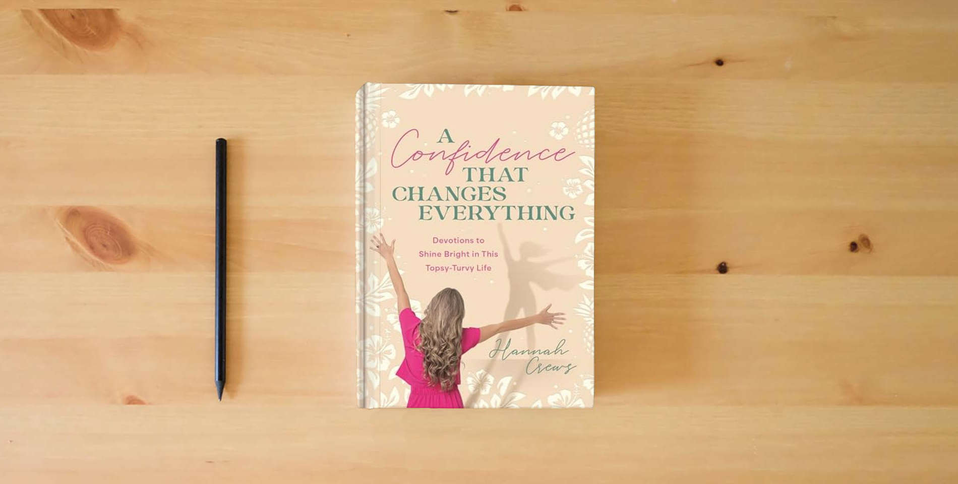 The book A Confidence That Changes Everything: Devotions to Shine Bright in This Topsy-Turvy Life is on the table