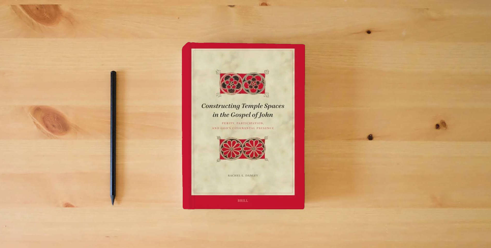 The book Constructing Temple Spaces in the Gospel of John: Purity, Participation, and God's Covenantal Presence (Biblical Interpretation Series, 242) is on the table