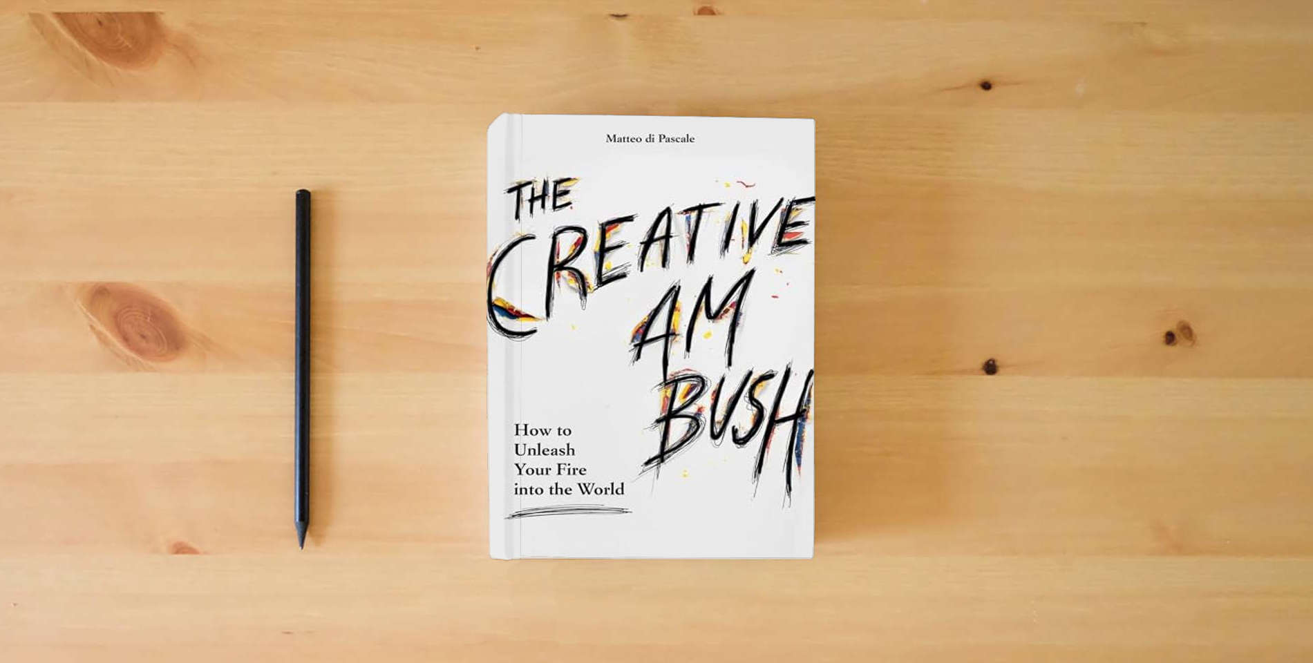 The book Creative Ambush: How to Unleash Your Fire into the World is on the table