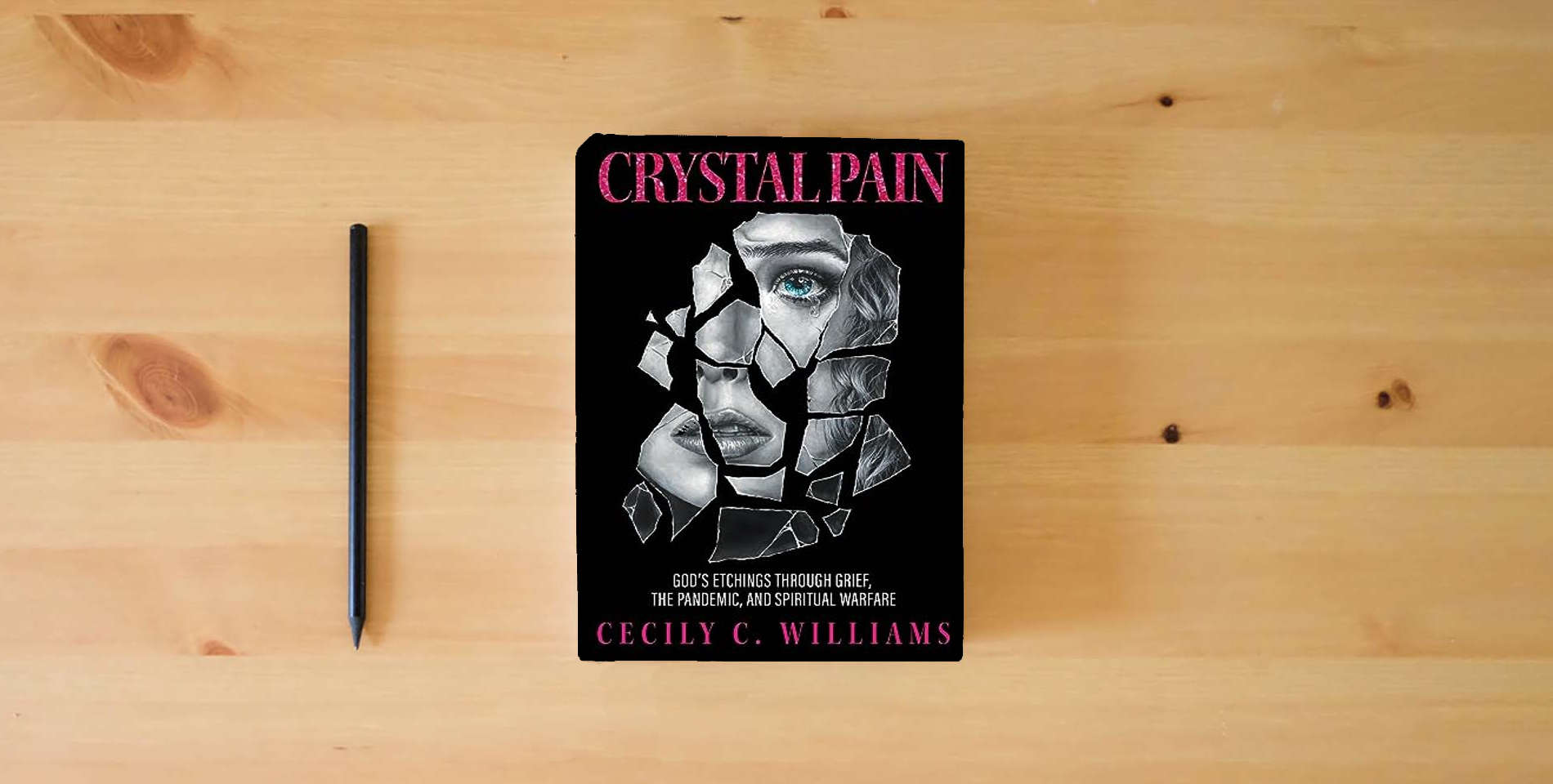 The book Crystal Pain: God's Etchings Through Grief, the Pandemic, and Spiritual Warfare is on the table