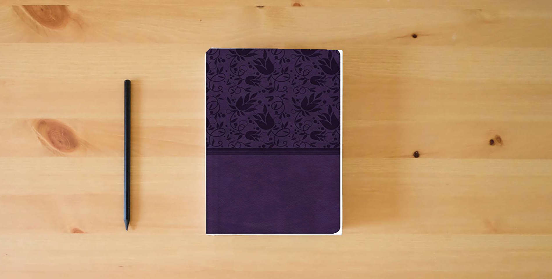 The book CSB Compact Ultrathin Bible, Purple LeatherTouch, Indexed is on the table