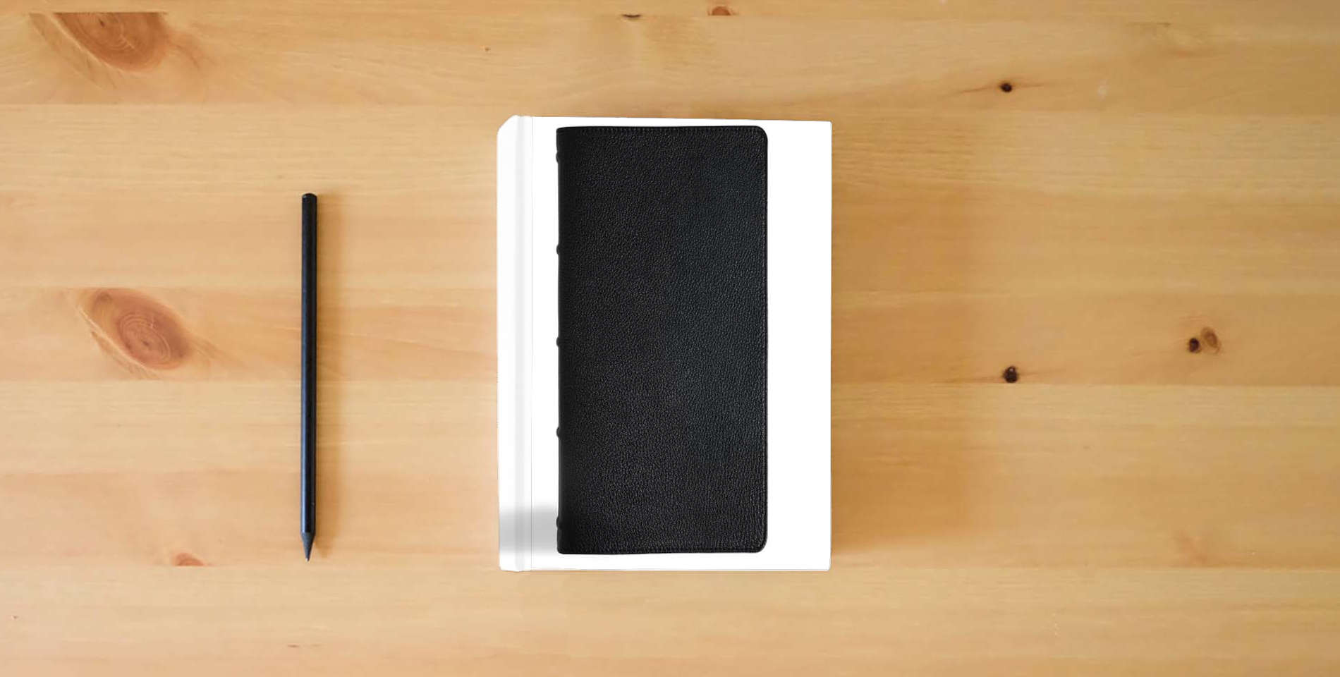 The book CSB Oswald Chambers Bible, Legacy Edition, Black Premium Goatskin, Includes My Utmost for His Highest Devotional, Bible Reading Plan, Commentary, Articles, Book Introductions, Callout Quotes is on the table