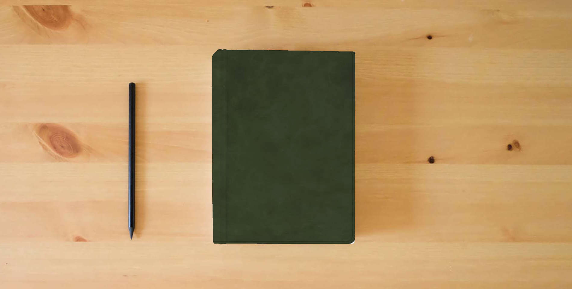 The book CSB Single-Column Compact Bible, Holman Handcrafted Collection, Zipper Closure, Olive Premium Calfskin, Black Letter, Presentation Page, Full-Color Maps, Easy-to-Read Bible Serif Type is on the table