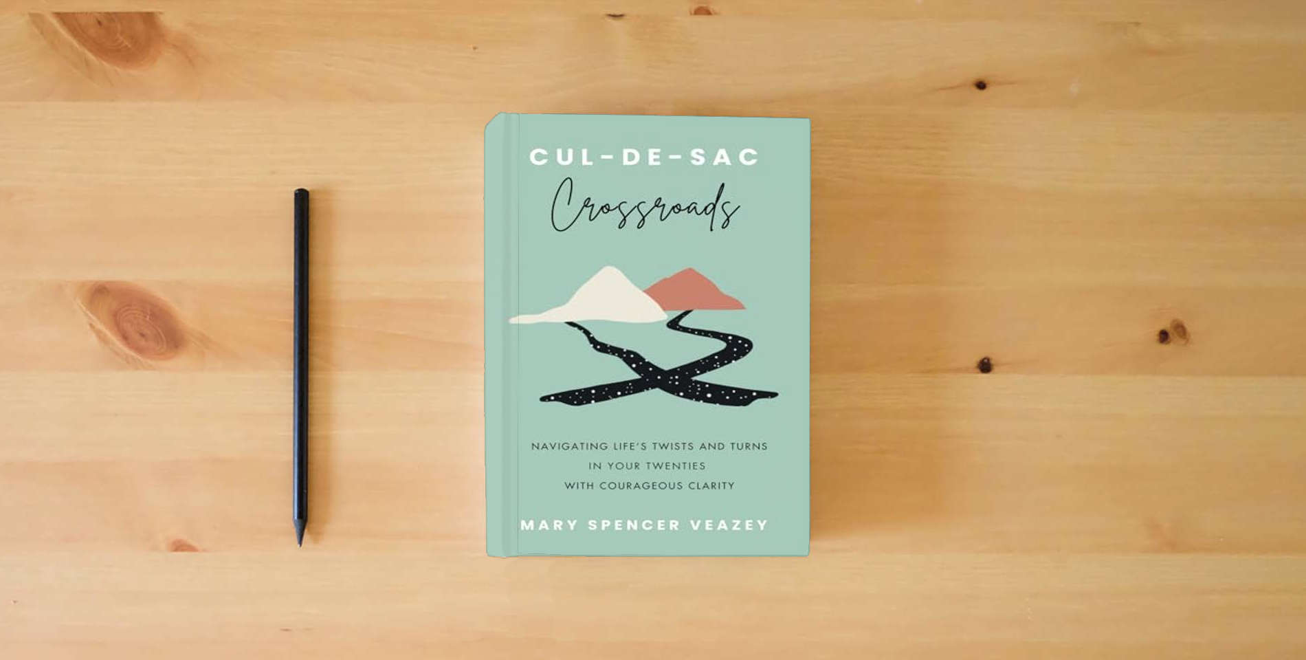 The book Cul-de-sac Crossroads: Navigating Life’s Twists and Turns in Your Twenties with Courageous Clarity is on the table