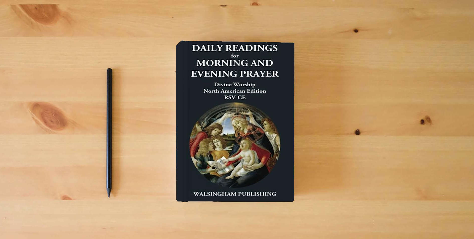 The book Daily Readings for Morning and Evening Prayer: Divine Worship North American Edition - RSV-CE is on the table