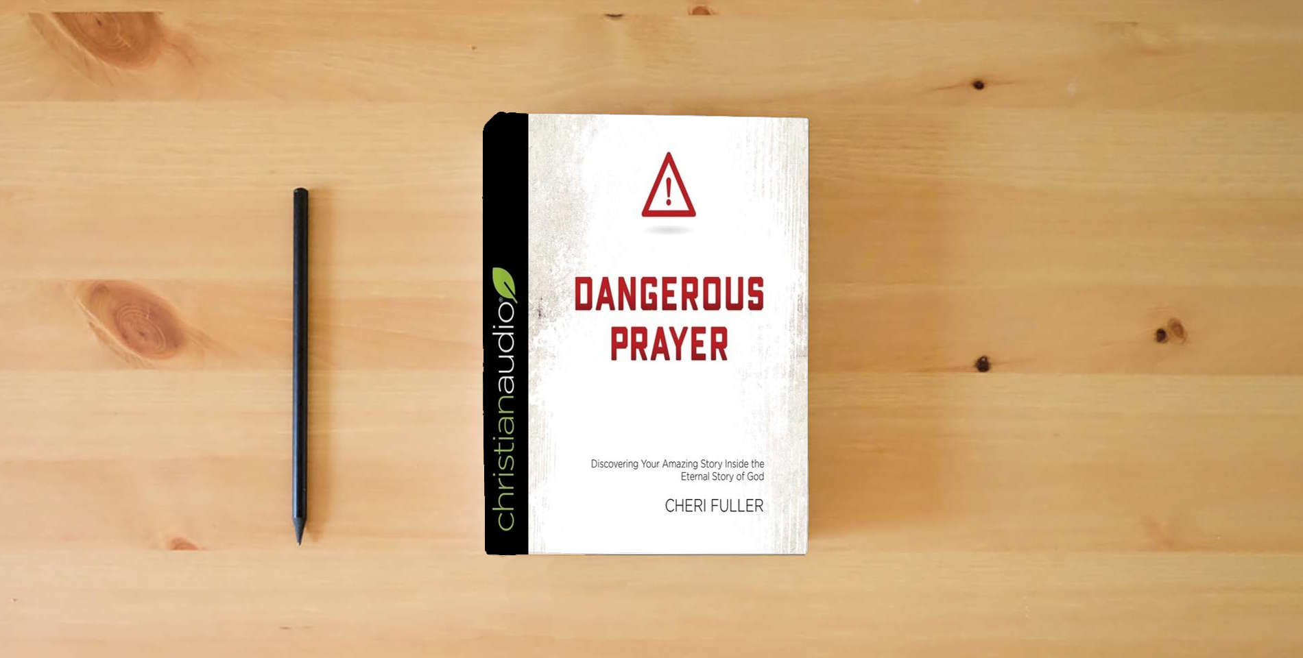 The book DANGEROUS PRAYER: Discovering Your Amazing Story Inside the Eternal Story of God is on the table