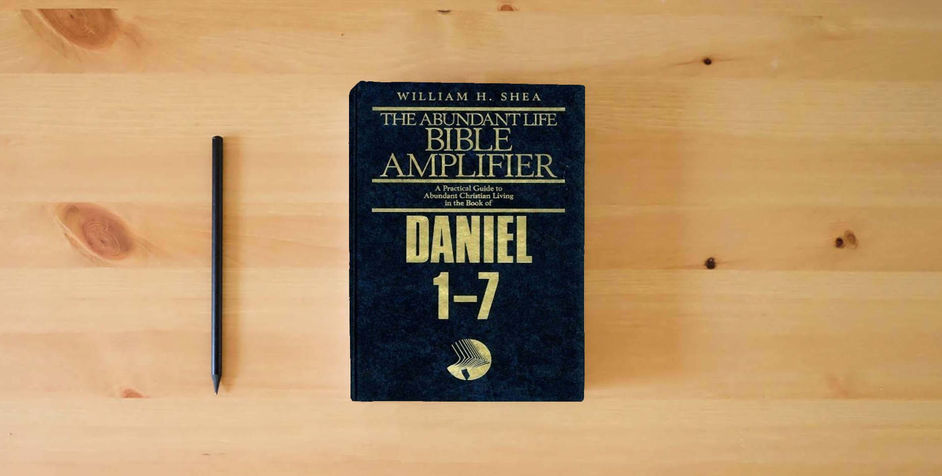 The book Daniel 1-7: Prophecy As History (Abundant Life Bible Amplifier) is on the table