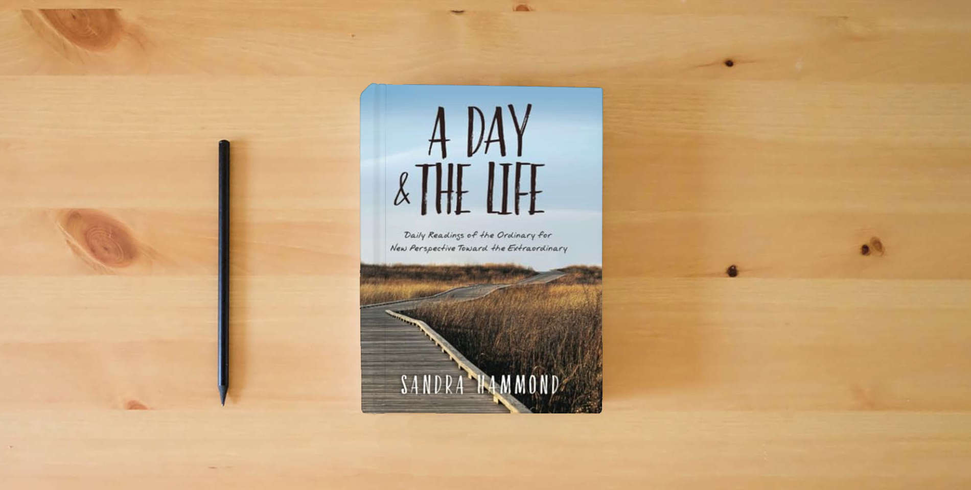 The book A Day & The Life: Daily Readings of the Ordinary for New Perspective Toward the Extraordinary is on the table