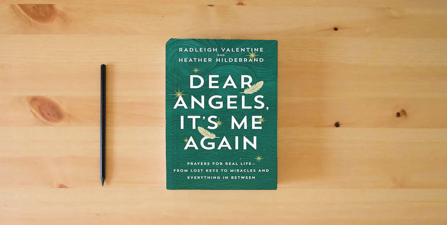 The book Dear Angels, It's Me Again: Prayers for Real Life--from Lost Keys to Miracles and Everything in Between is on the table