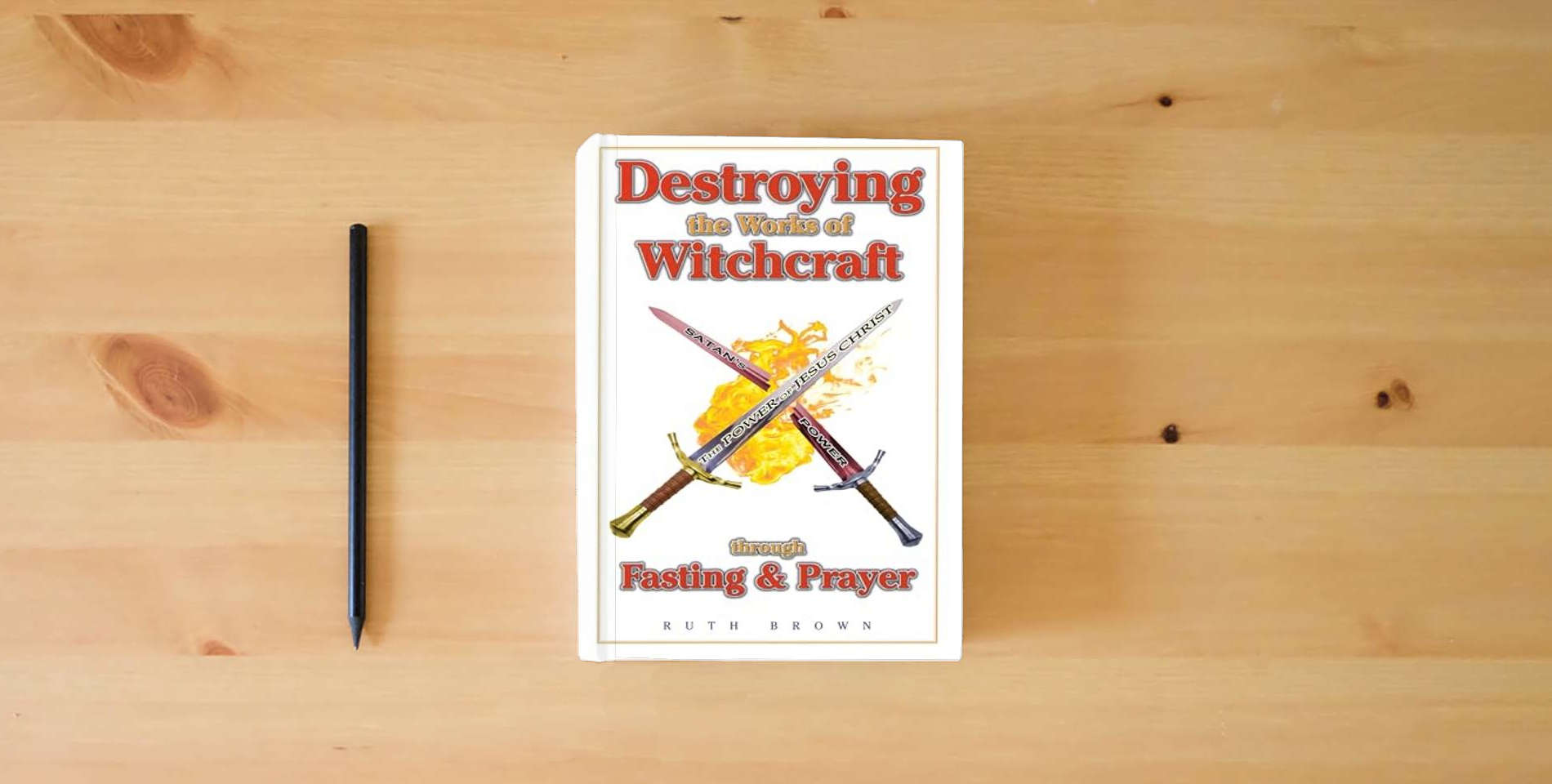 The book Destroying the Works of Witchcraft through Fasting and Prayer is on the table