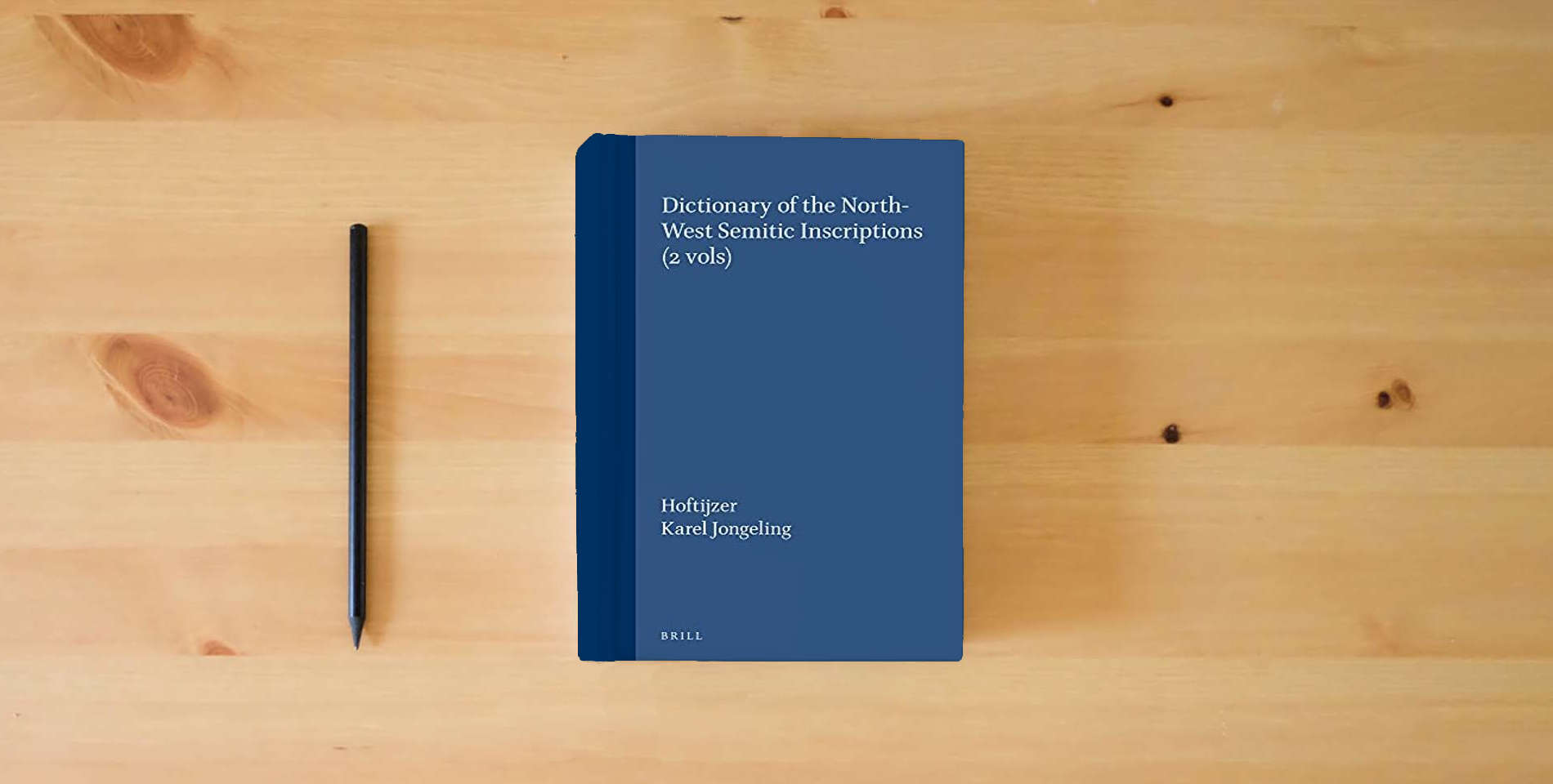 The book Dictionary of the North-West Semitic Inscriptions (Handbook of Oriental Studies/Handbuch Der Orientalistik) (Handbook of Oriental Studies: Section 1; The Near and Middle East) is on the table