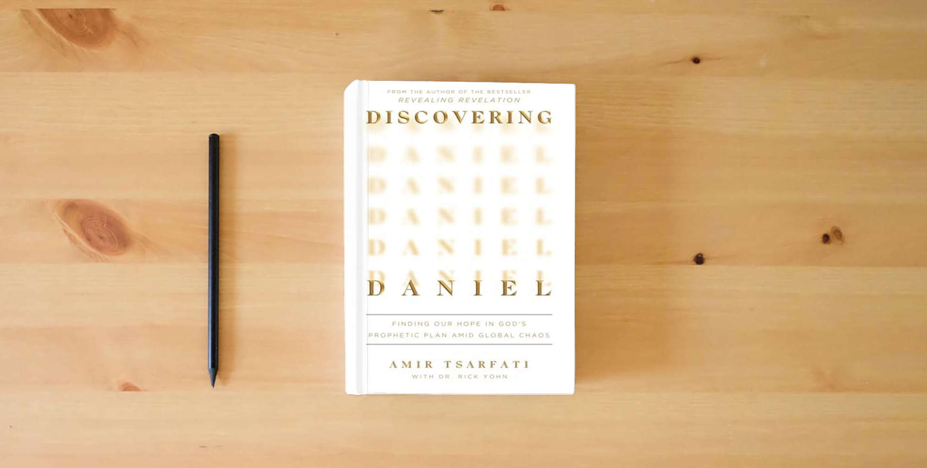 The book Discovering Daniel: Finding Our Hope in God’s Prophetic Plan Amid Global Chaos is on the table
