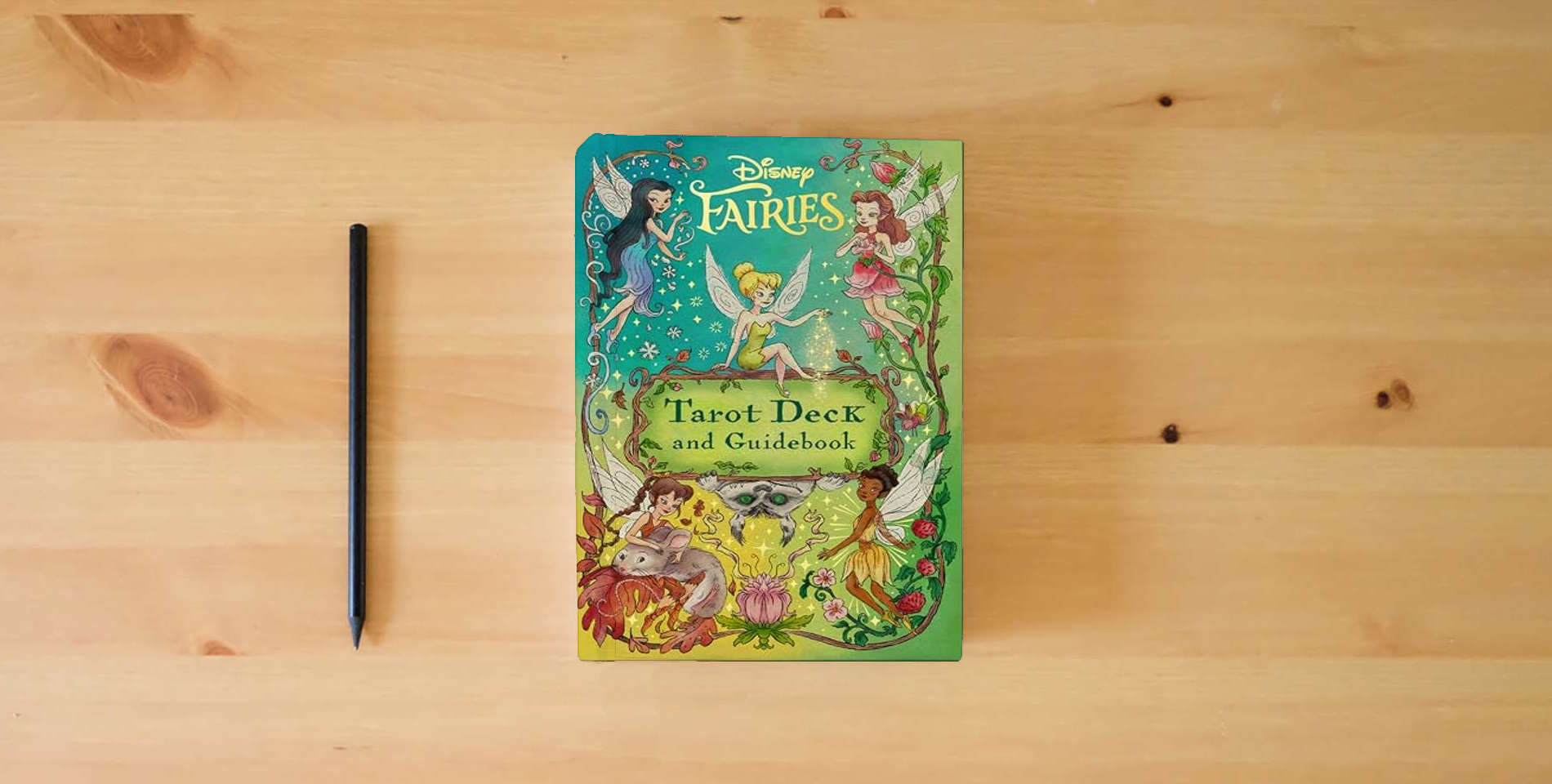 The book Disney Fairies Tarot Deck and Guidebook is on the table
